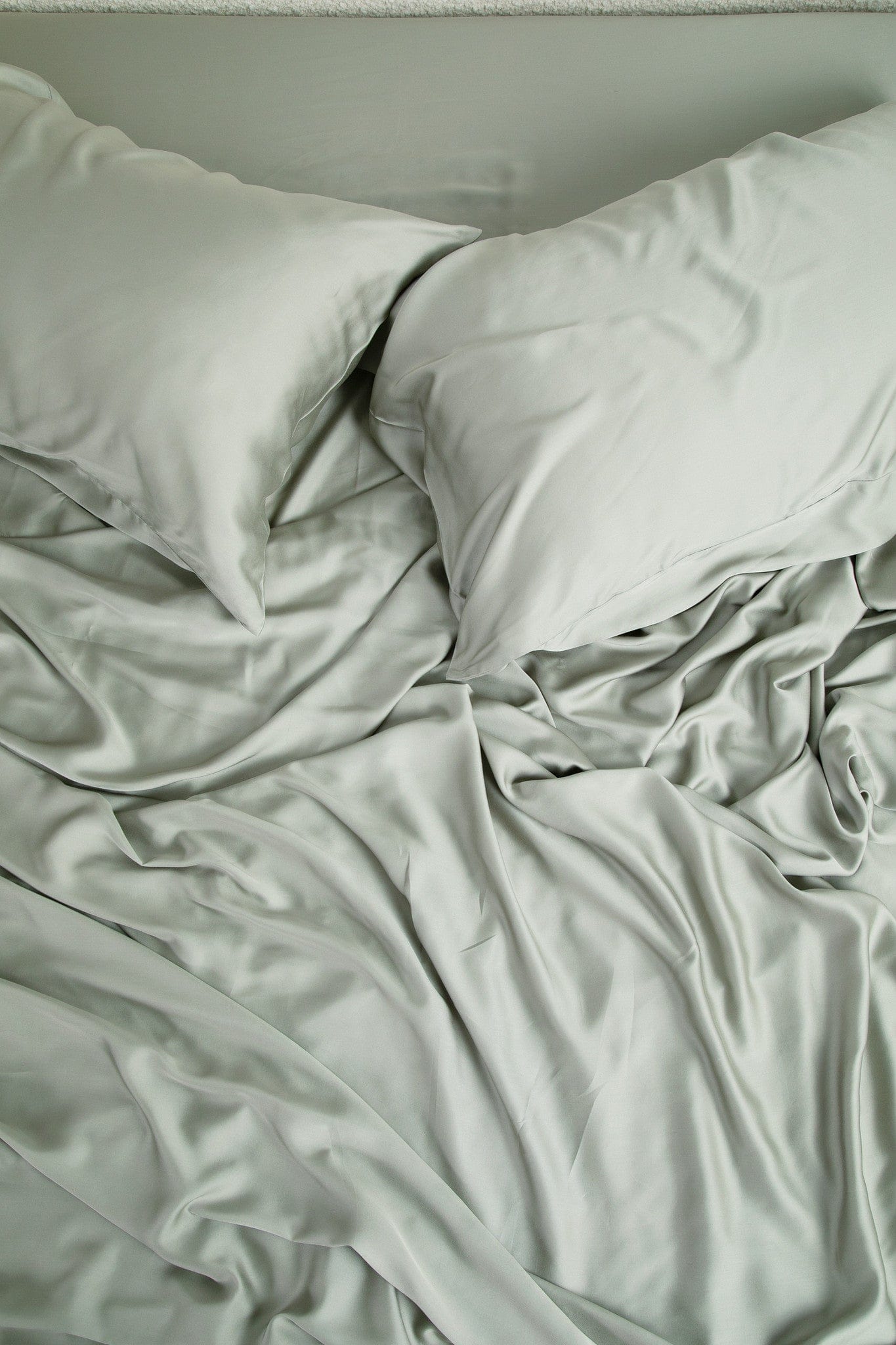 Close up of the Bamboo Sateen Sheet Set in Eucalyptus shown on a bed