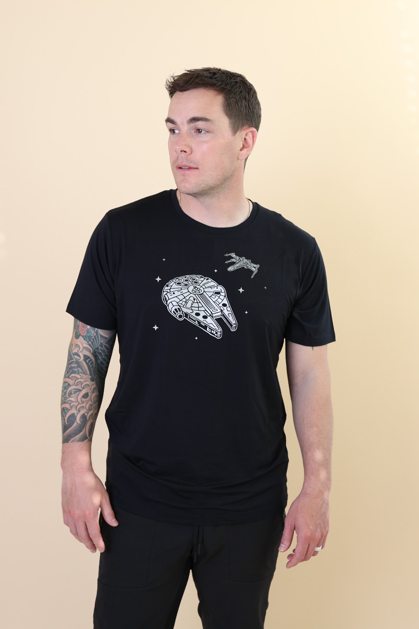 Male modeling the Men's Crew Neck Tee in Millennium Falcon™ with black jeans