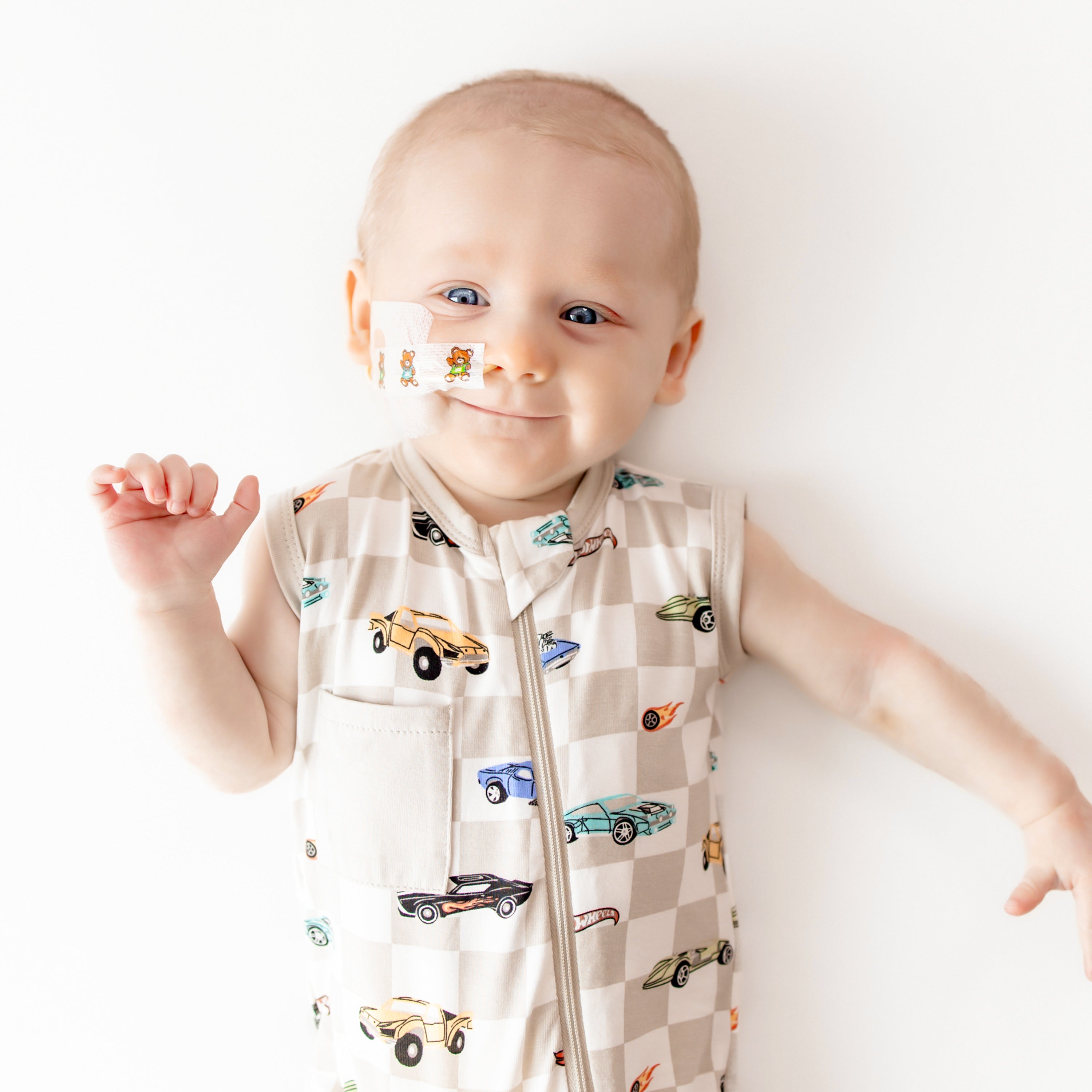 Close up of smiling model wearing the Zippered Sleeveless Romper in Fast and Fierce