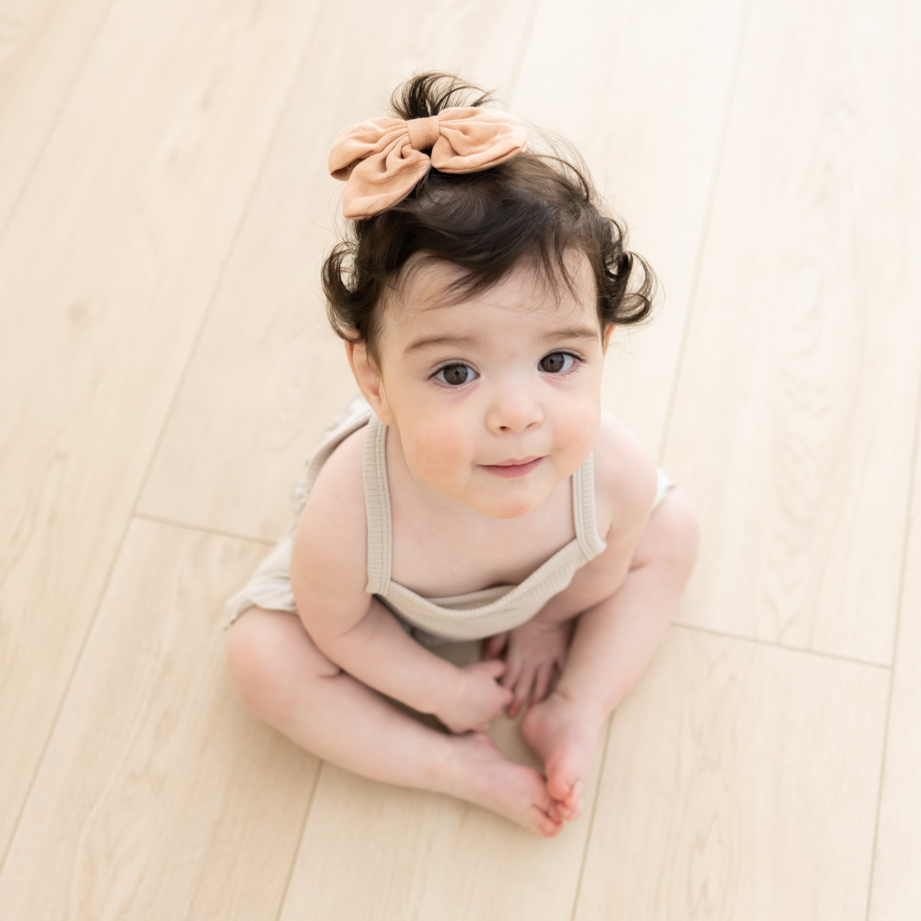 Baby wearing Bamboo Muslin Clip-in Bow in Fawn