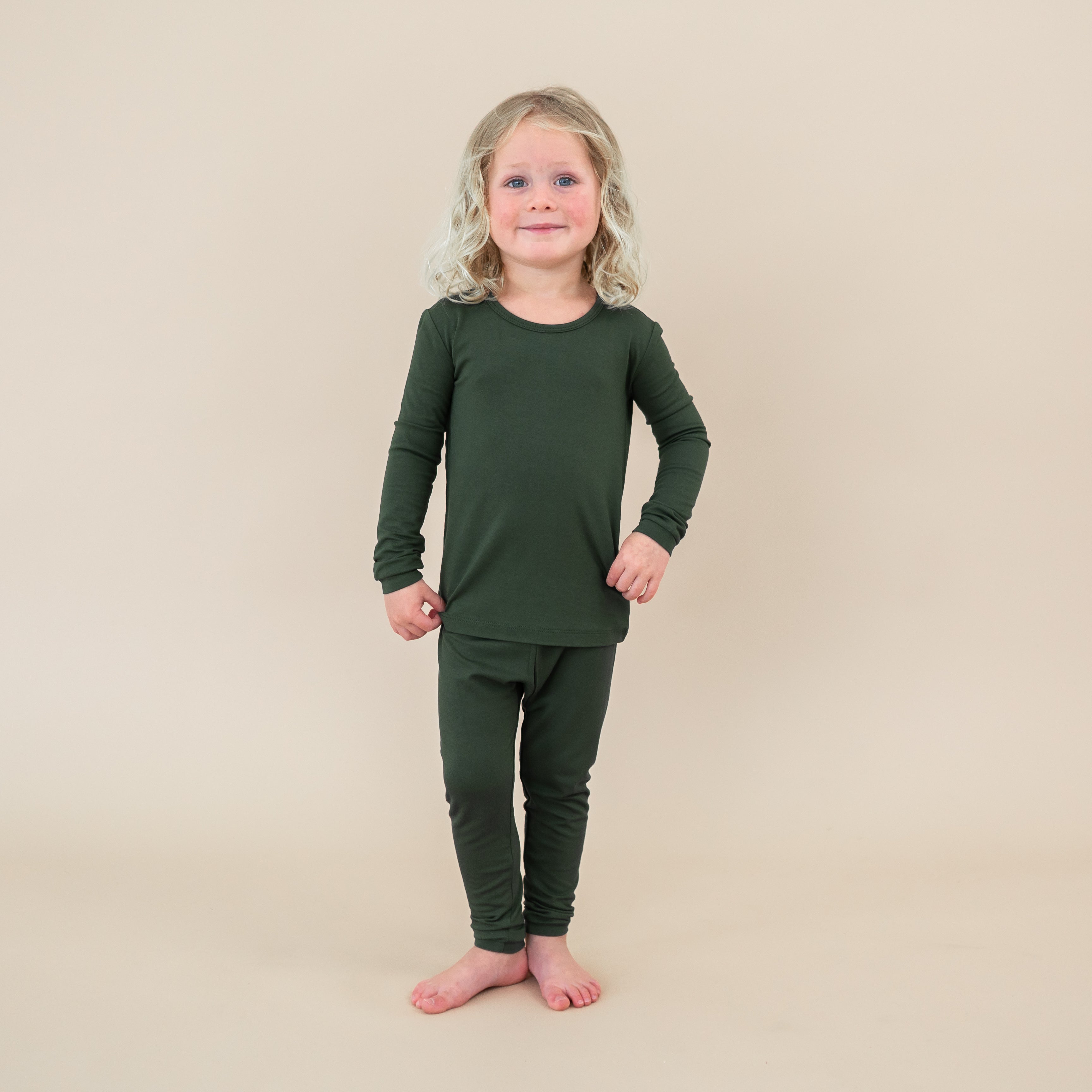 Child wearing a Long Sleeve Pajamas in Fir on a beige background