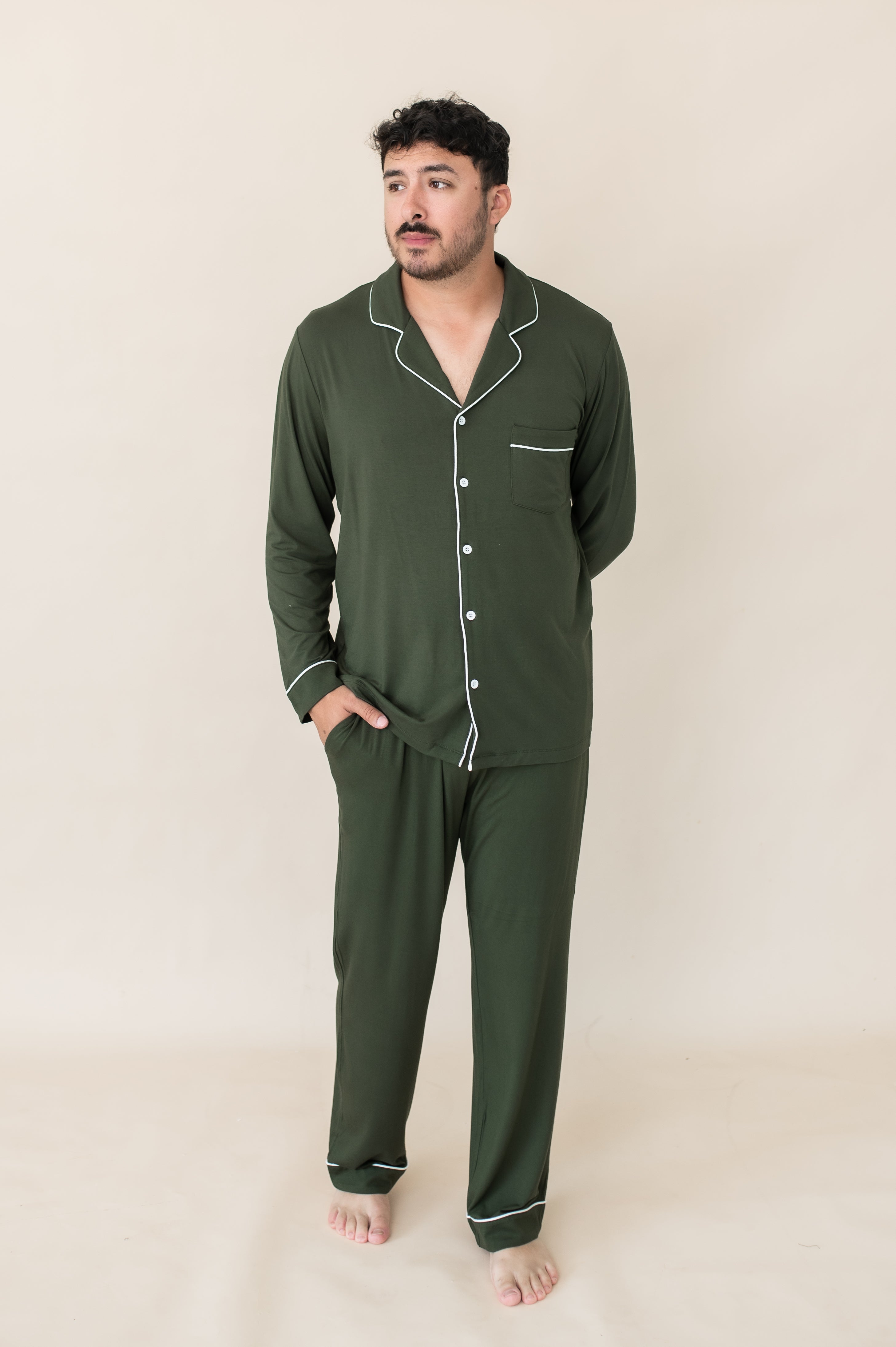 Male model wearing the Men's Long Sleeve Pajama Set in Fir with one hand in the pants pocket and the other behind his back
