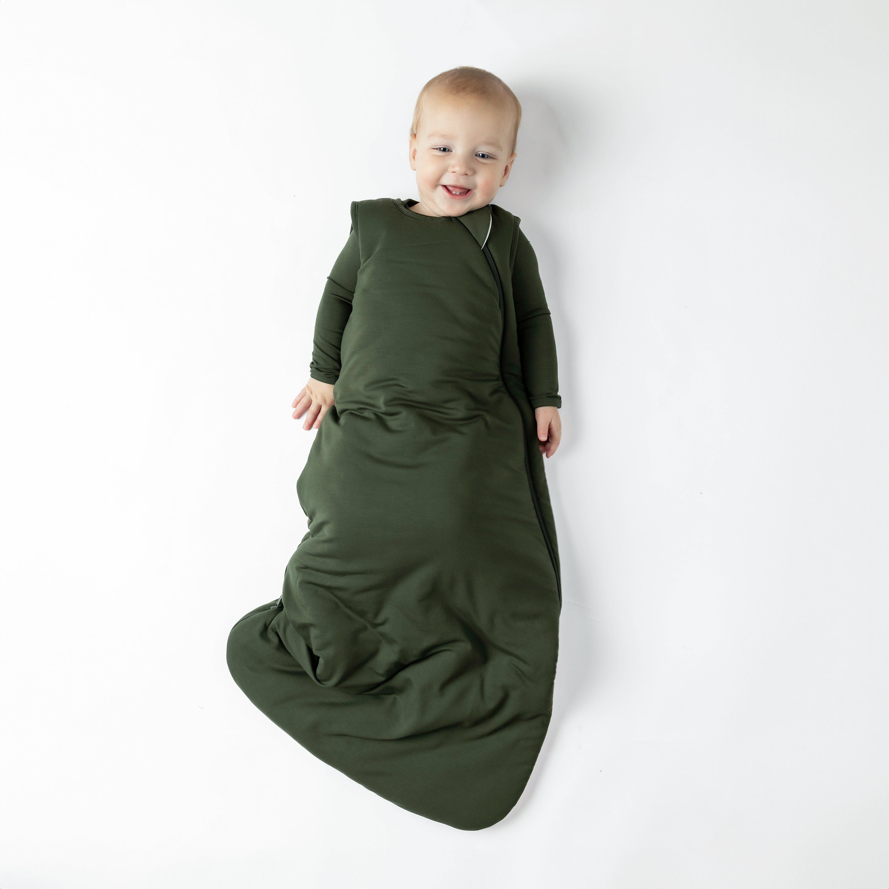 Baby wearing Sleep Bag in Fir 2.5 on a white background
