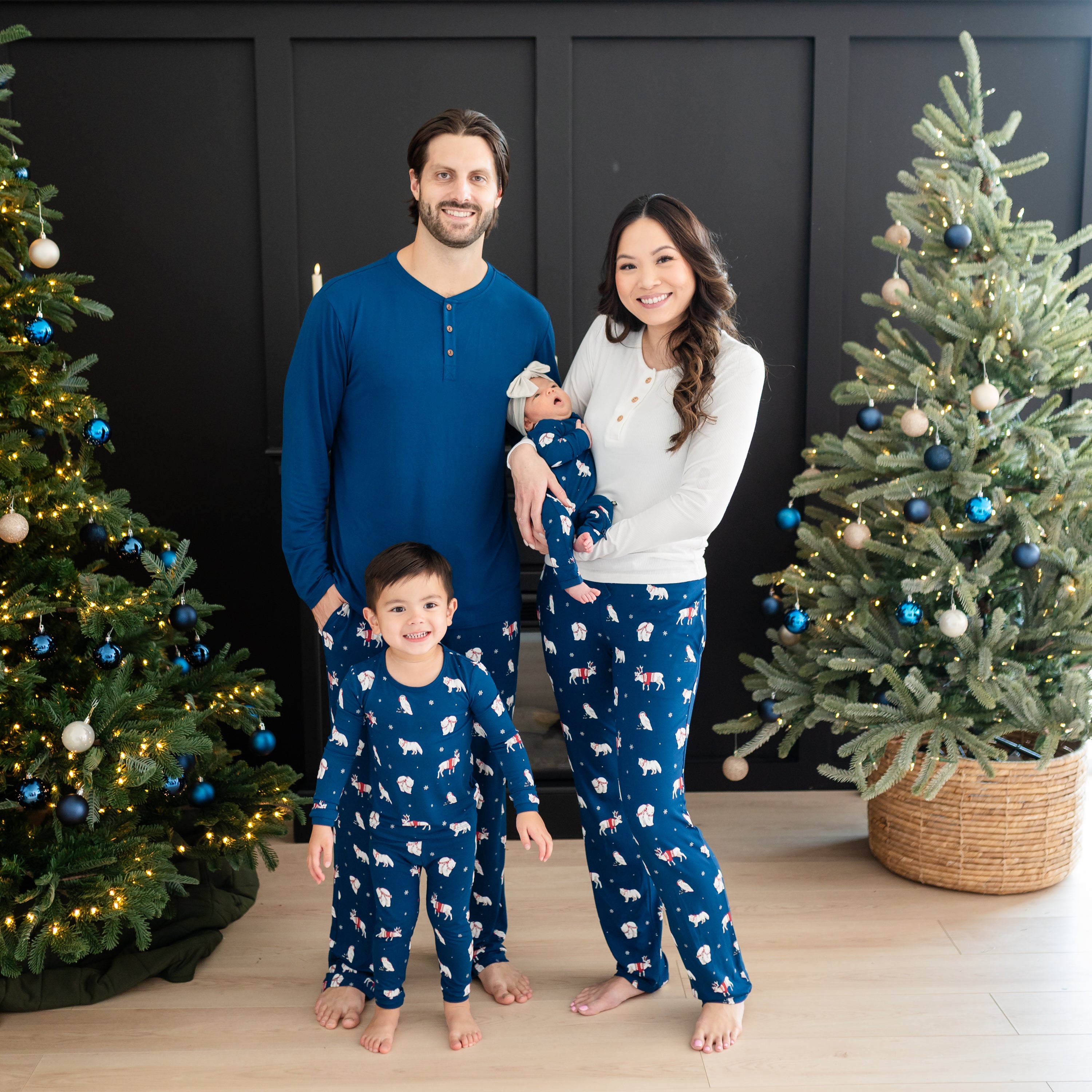 Family of 4 wearing various items all matching in the Holiday Print Frosty Friends