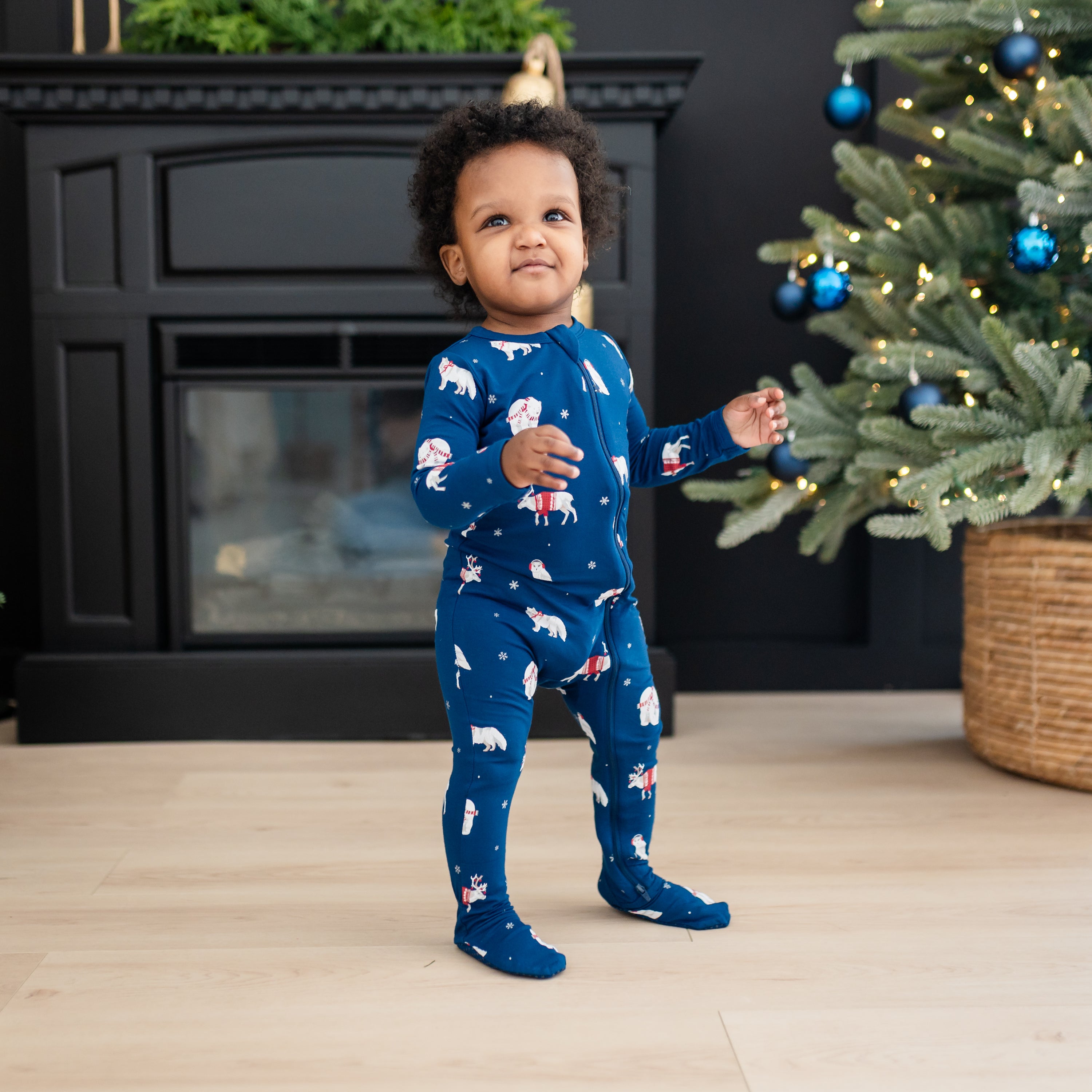 Young toddler walking wearing the Zippered Footie in Frosty Friends