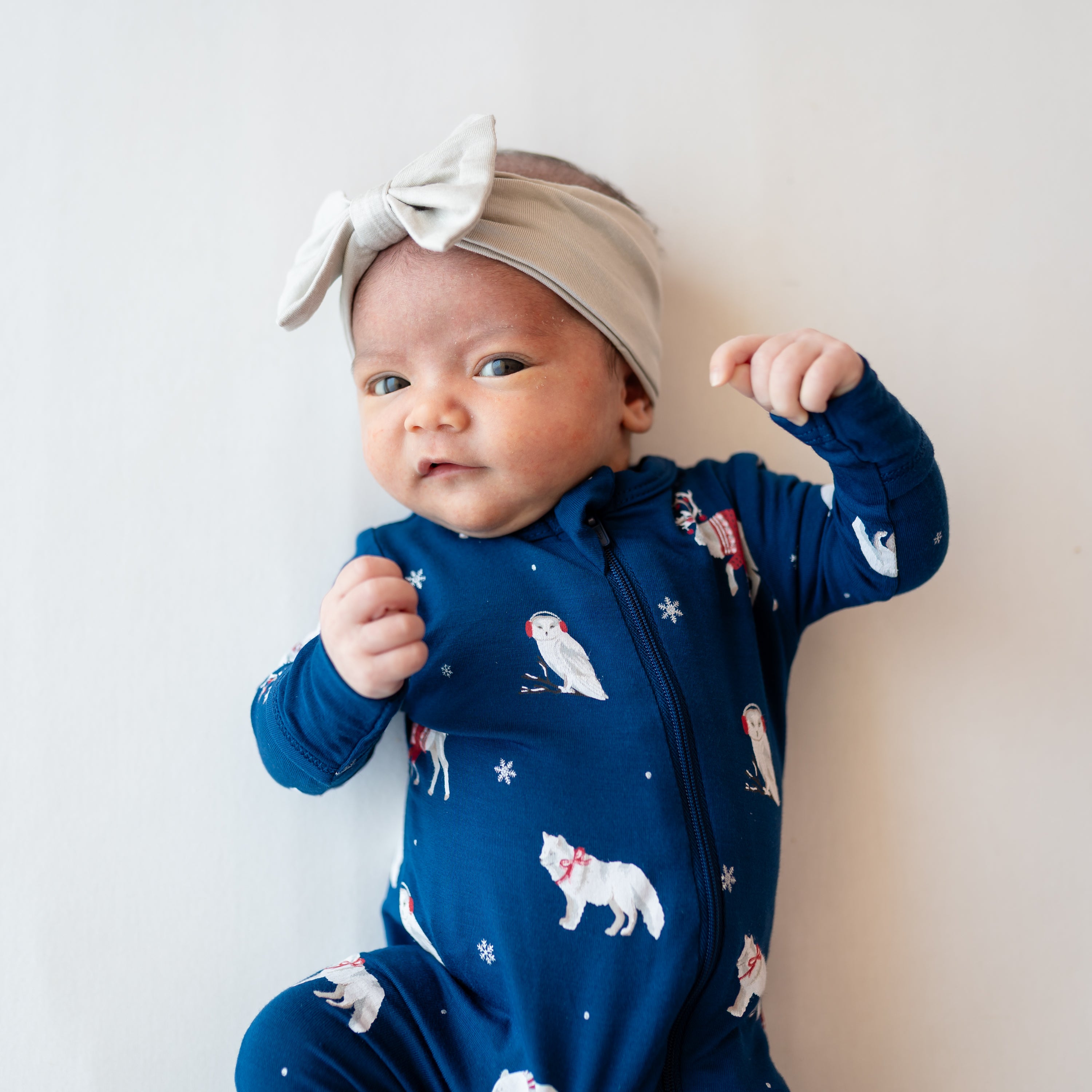 Close up of newborn wearing the Zippered Romper in Frosty Friends