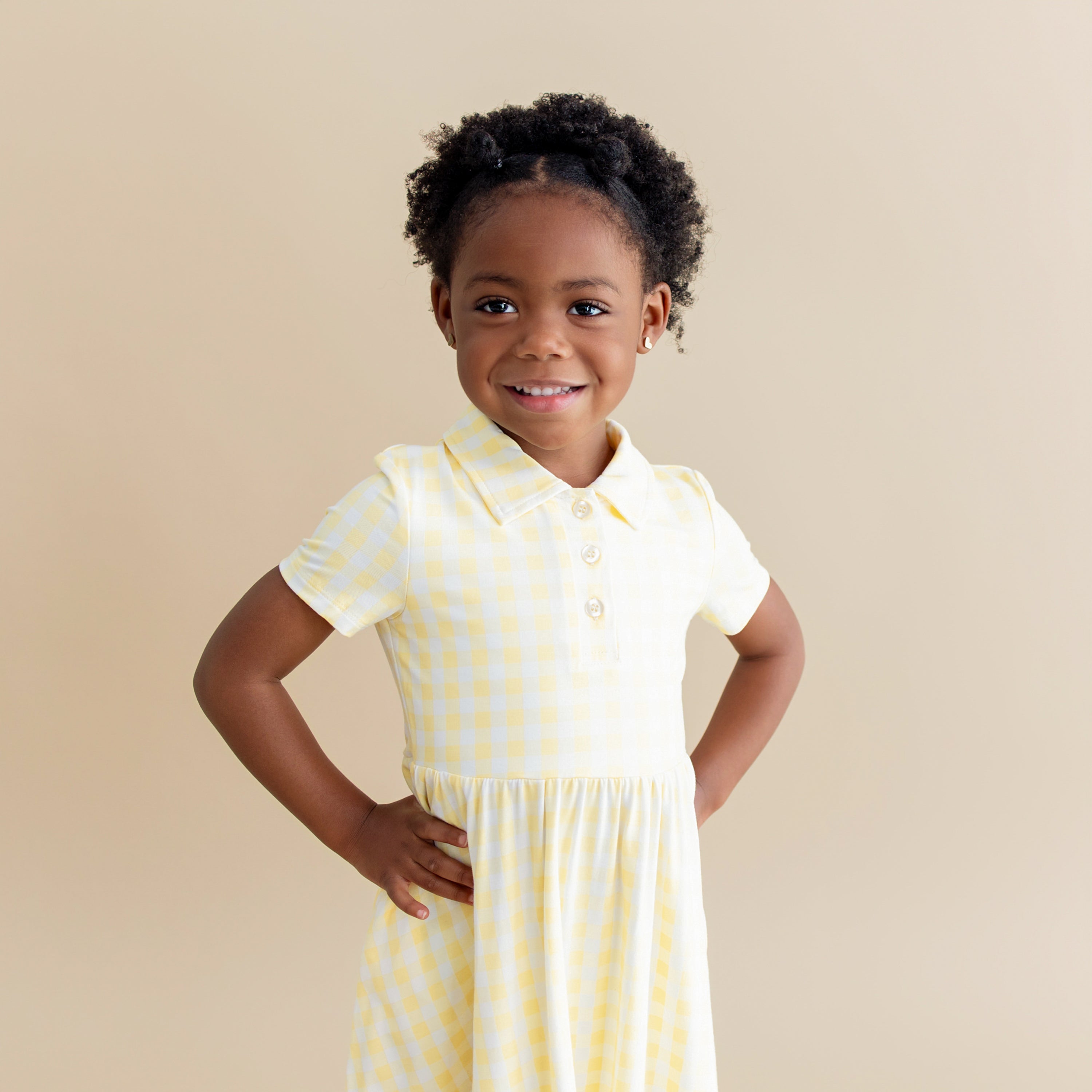 Close of young girl wearing the Polo Dress in Gingham Chamomile