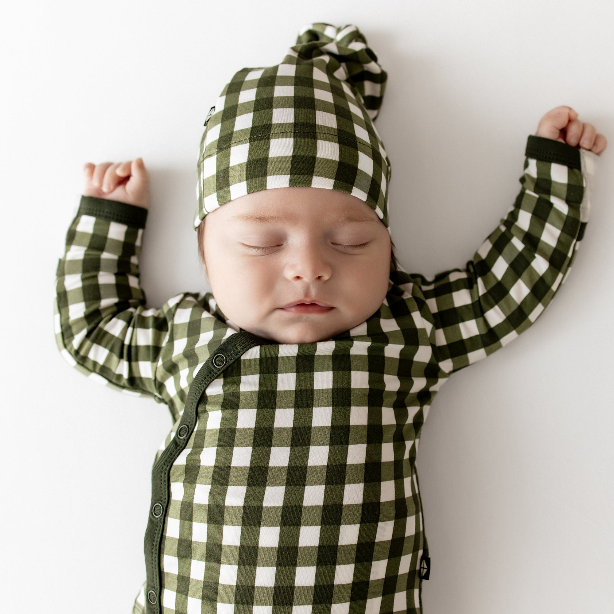 Close up of sleeping infant wearing the Take Me Home Set with Cap in Gingham Fir