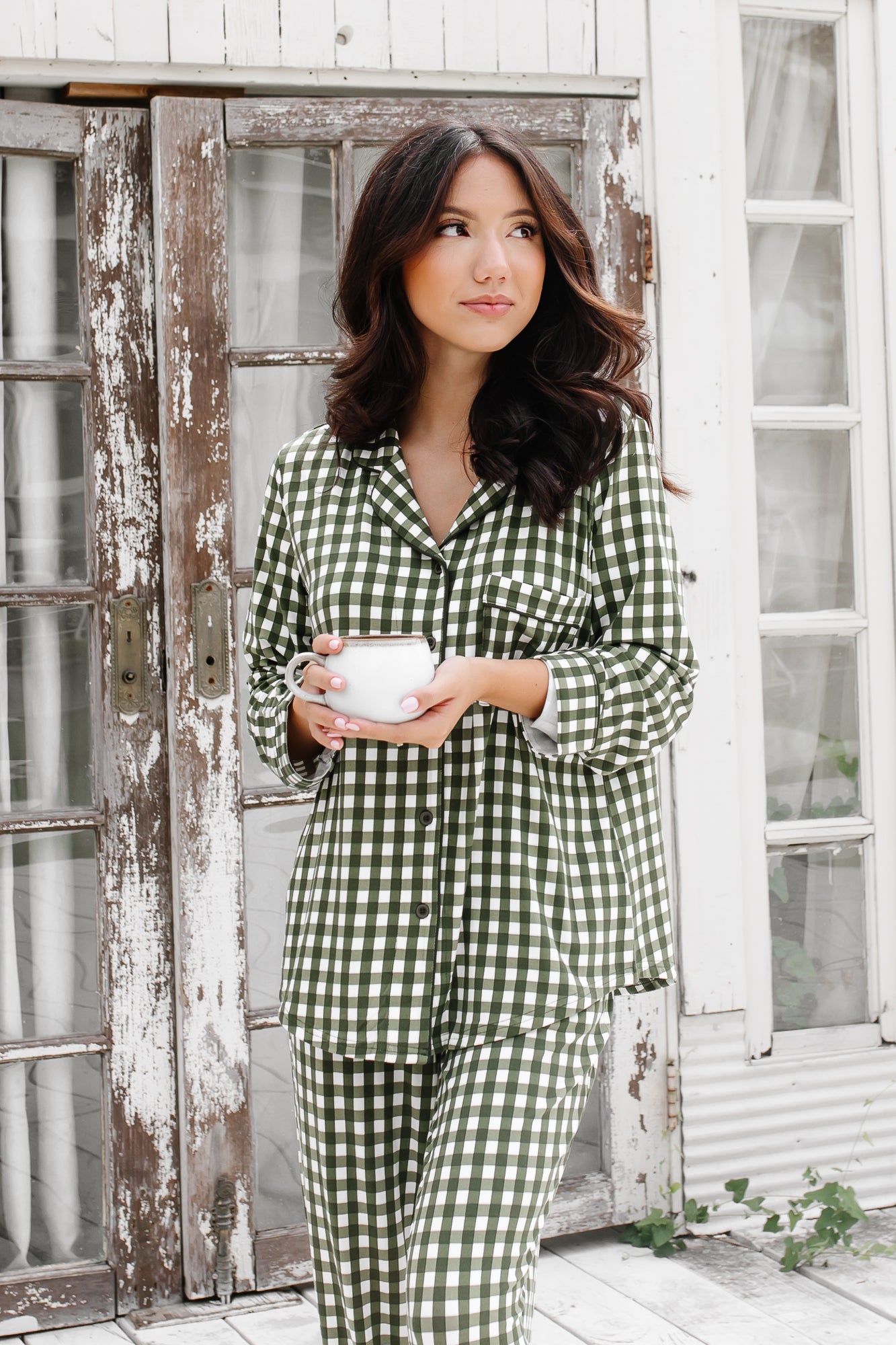 Close up of female wearing the Long-Sleeved Women's Pajama Set in Gingham Fir holding a cup of coffee