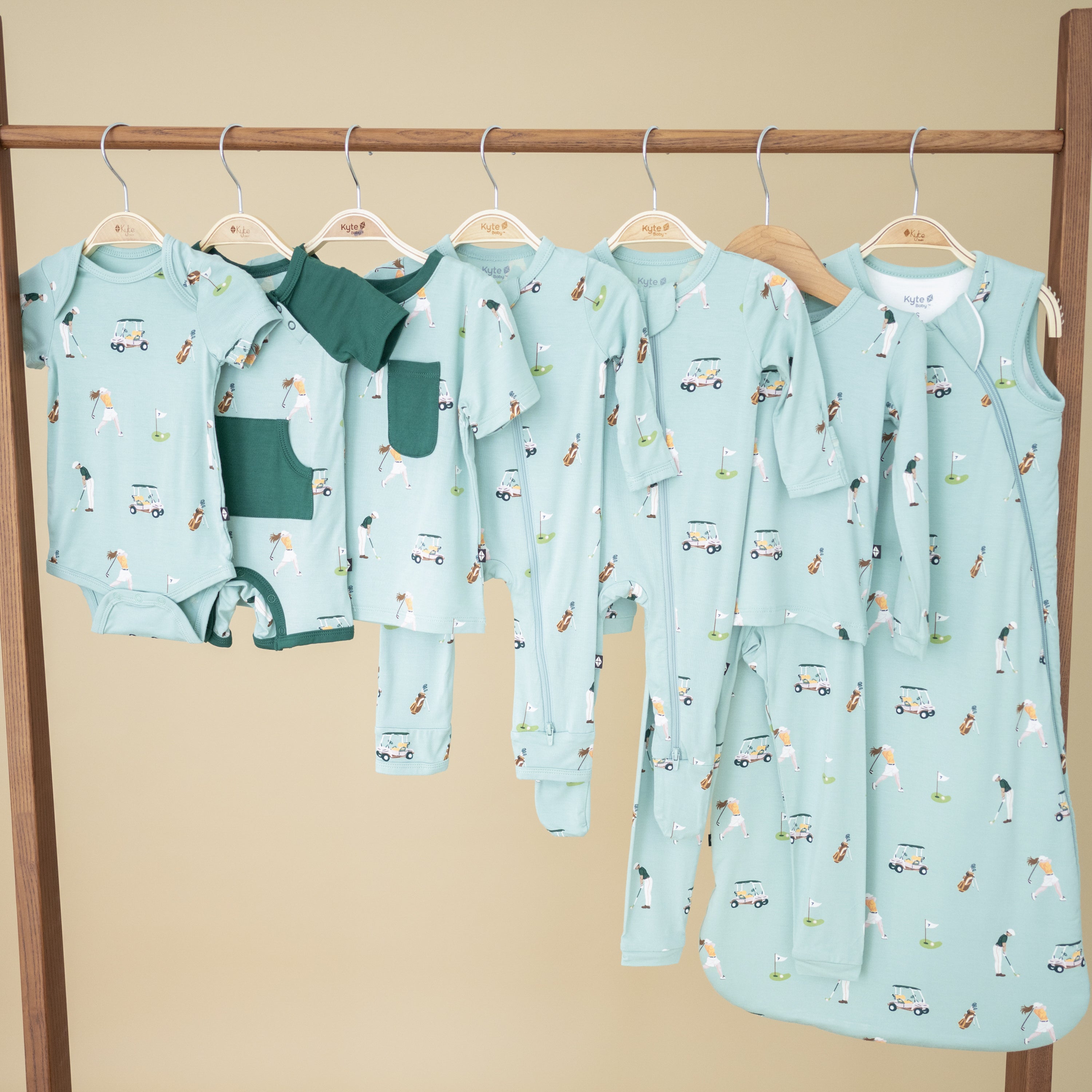 Hanging rack of bamboo infant clothes in Golf print