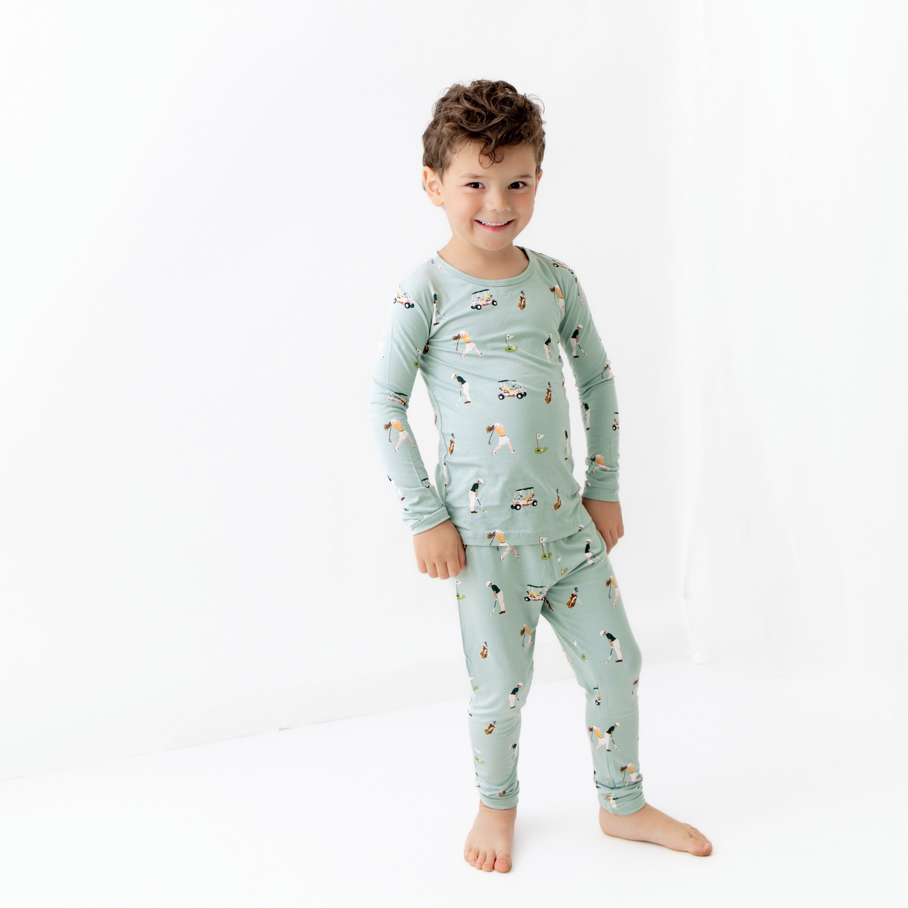 Toddler modeling bamboo Long Sleeve Pajamas in Golf