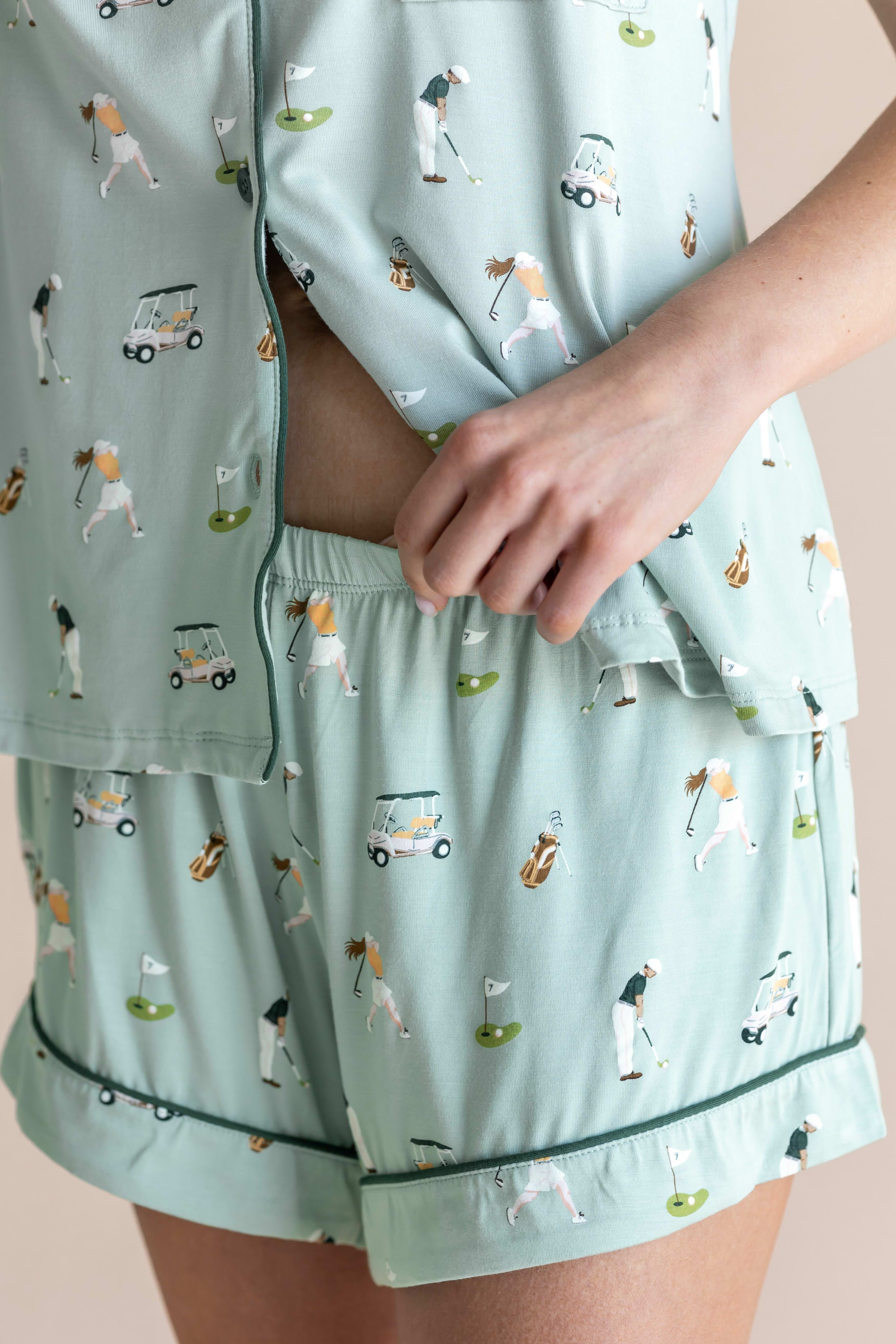 Model showcasing the shorts of Women's Short Sleeve Pajama Set in Golf print on beige background