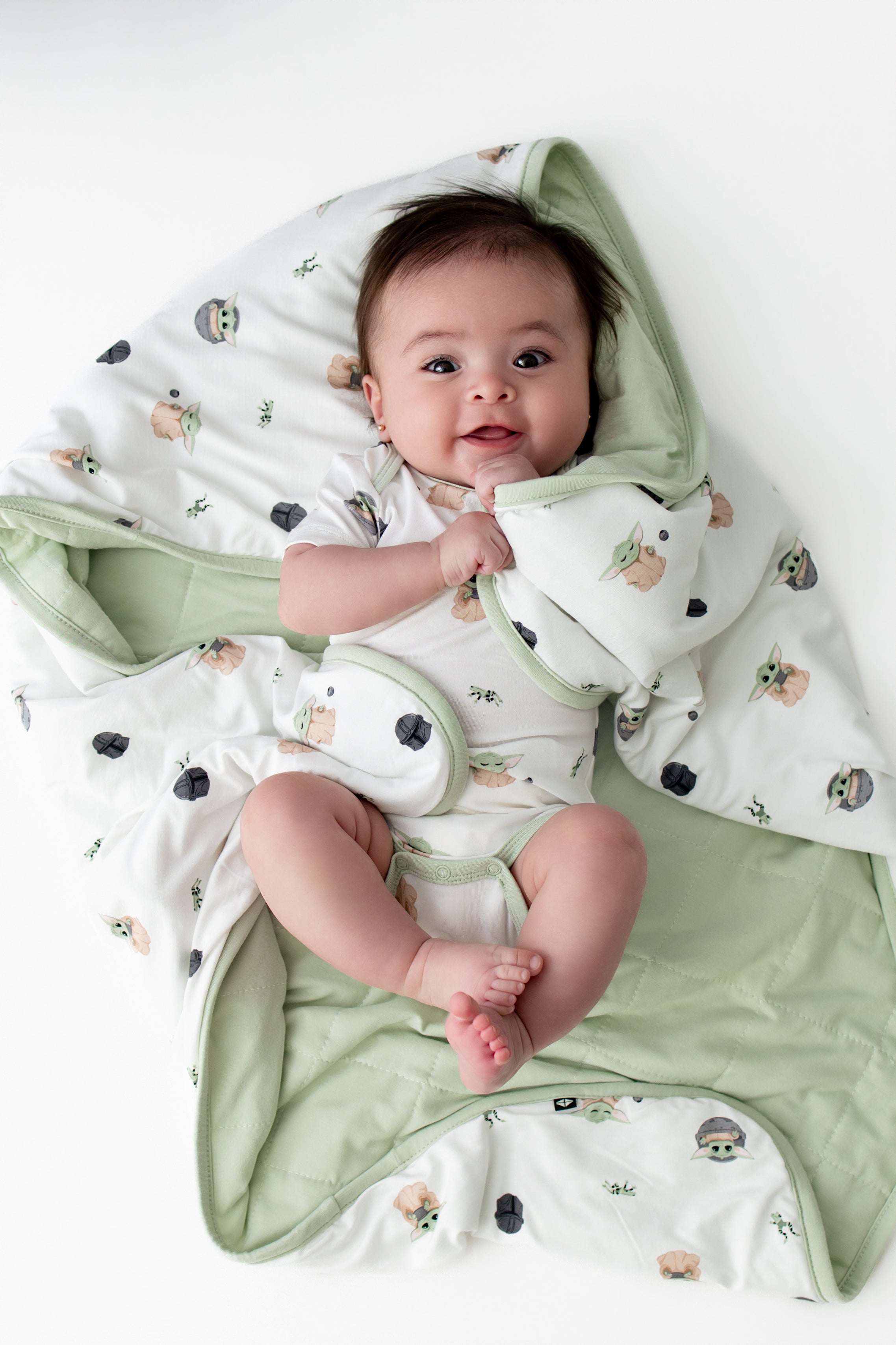 Infant laying on a Baby Blanket in Grogu™ wearing a matching short sleeve bodysuit