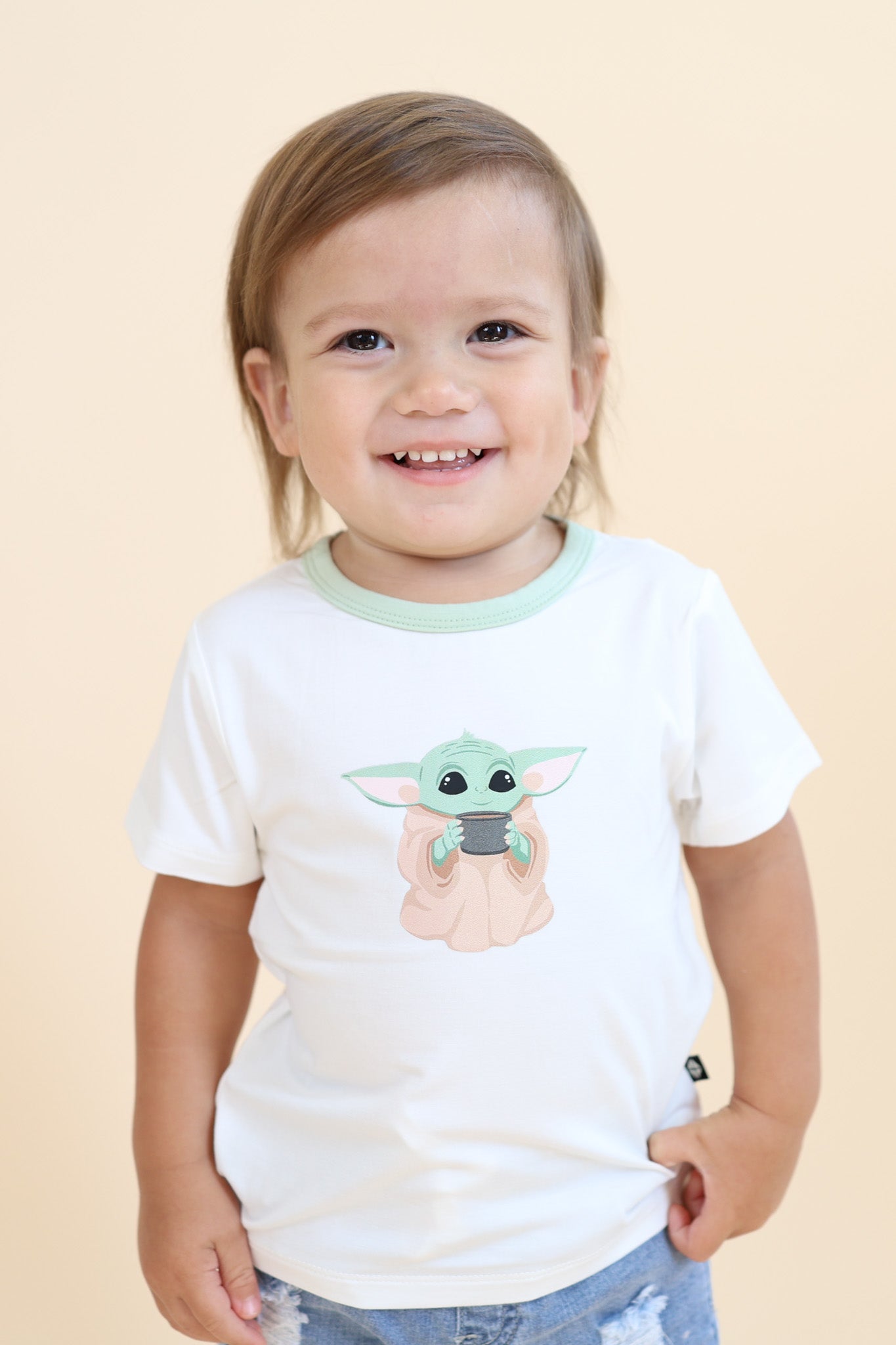 Young boy wearing the Toddler Basic Tee in The Child™ paired with light wash jeans