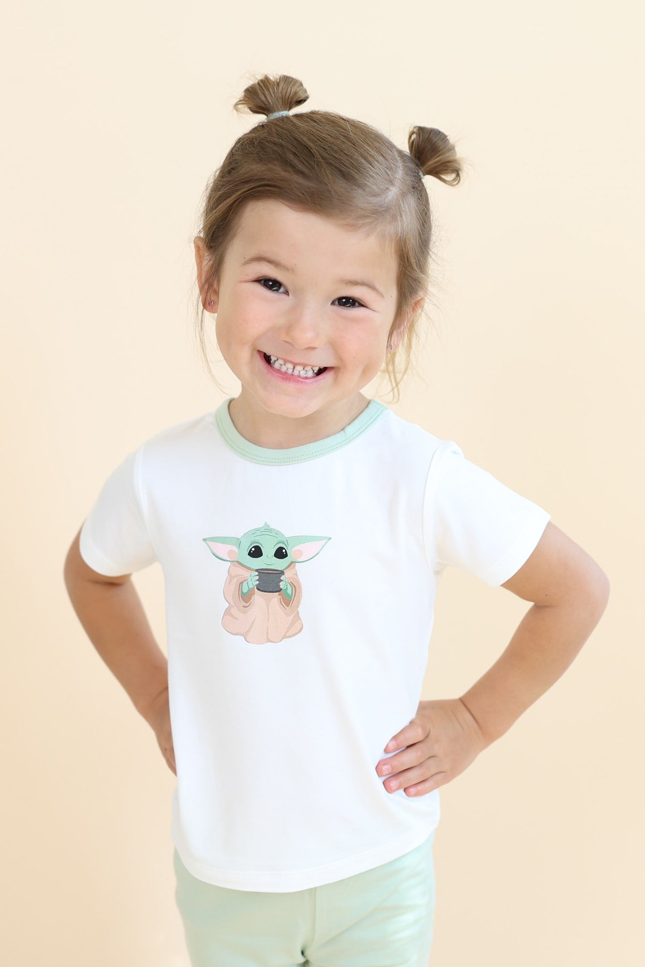 Young smiling girl posing wearing the Toddler Basic Tee in The Child™