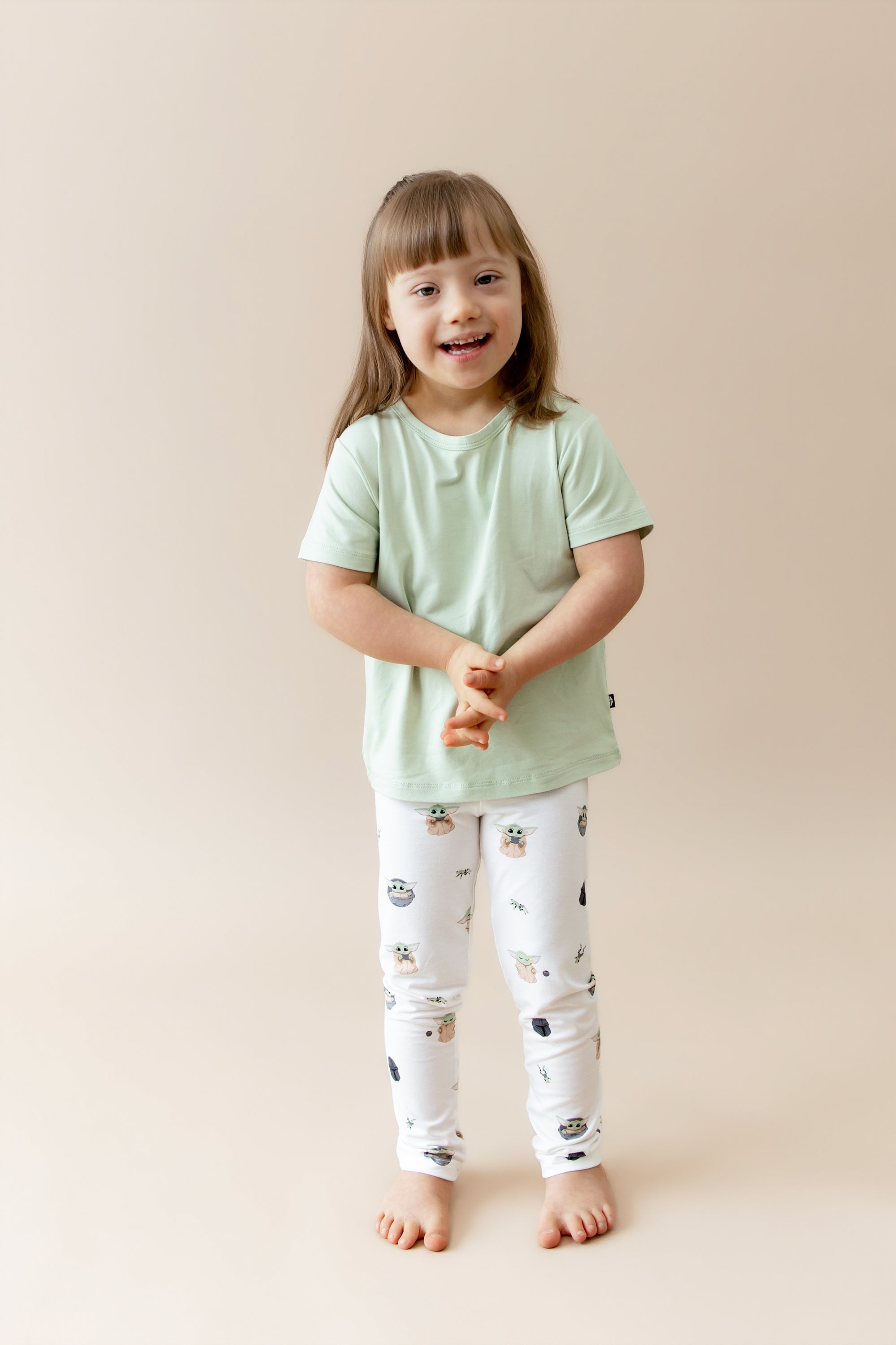 Young girl wearing the Toddler Leggings in Grogu™ paired with a light green shirt