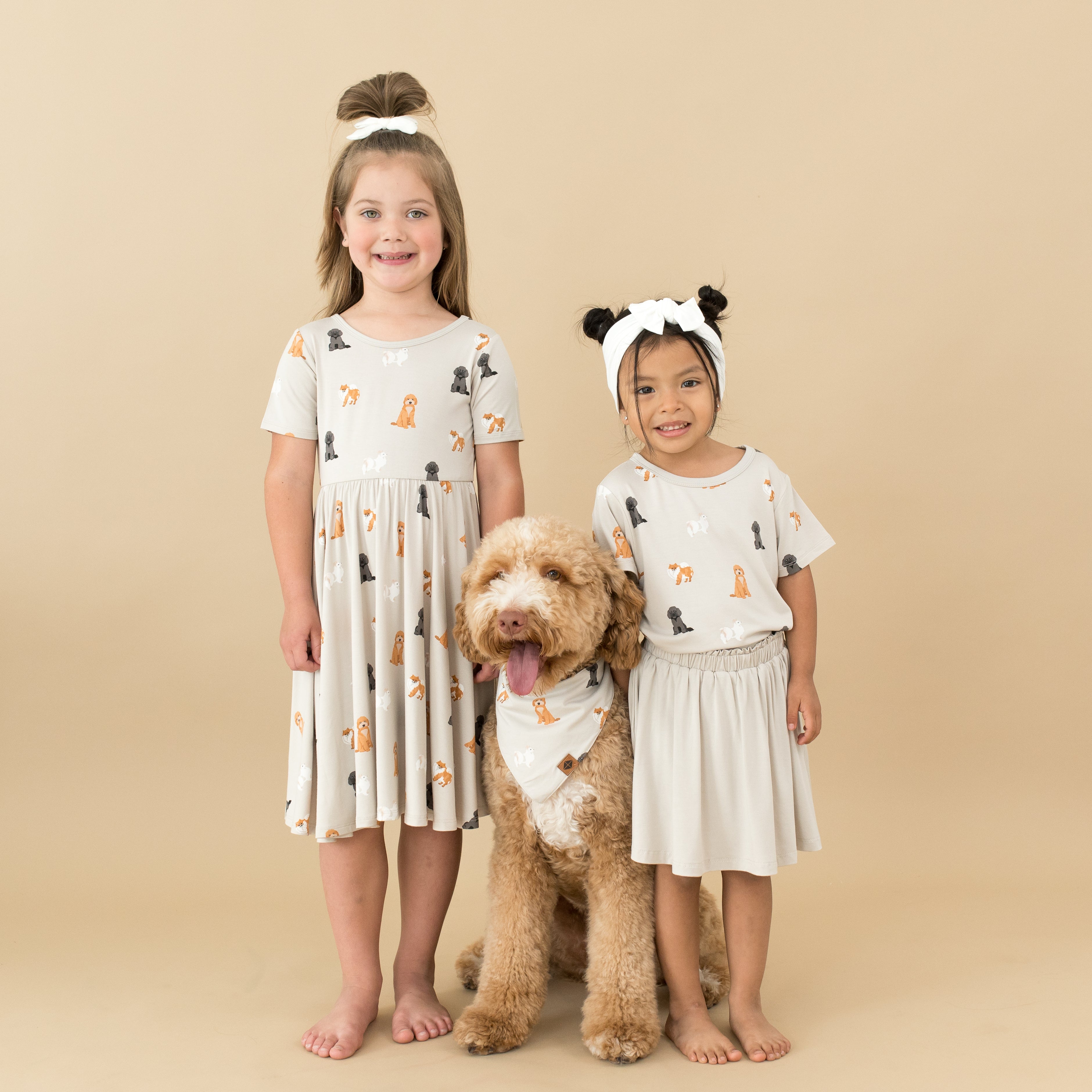 2 children and dog modeling Kyte Baby Fluffy Dog collection in Twirl Dress, Basic Tee and Dog Bandana