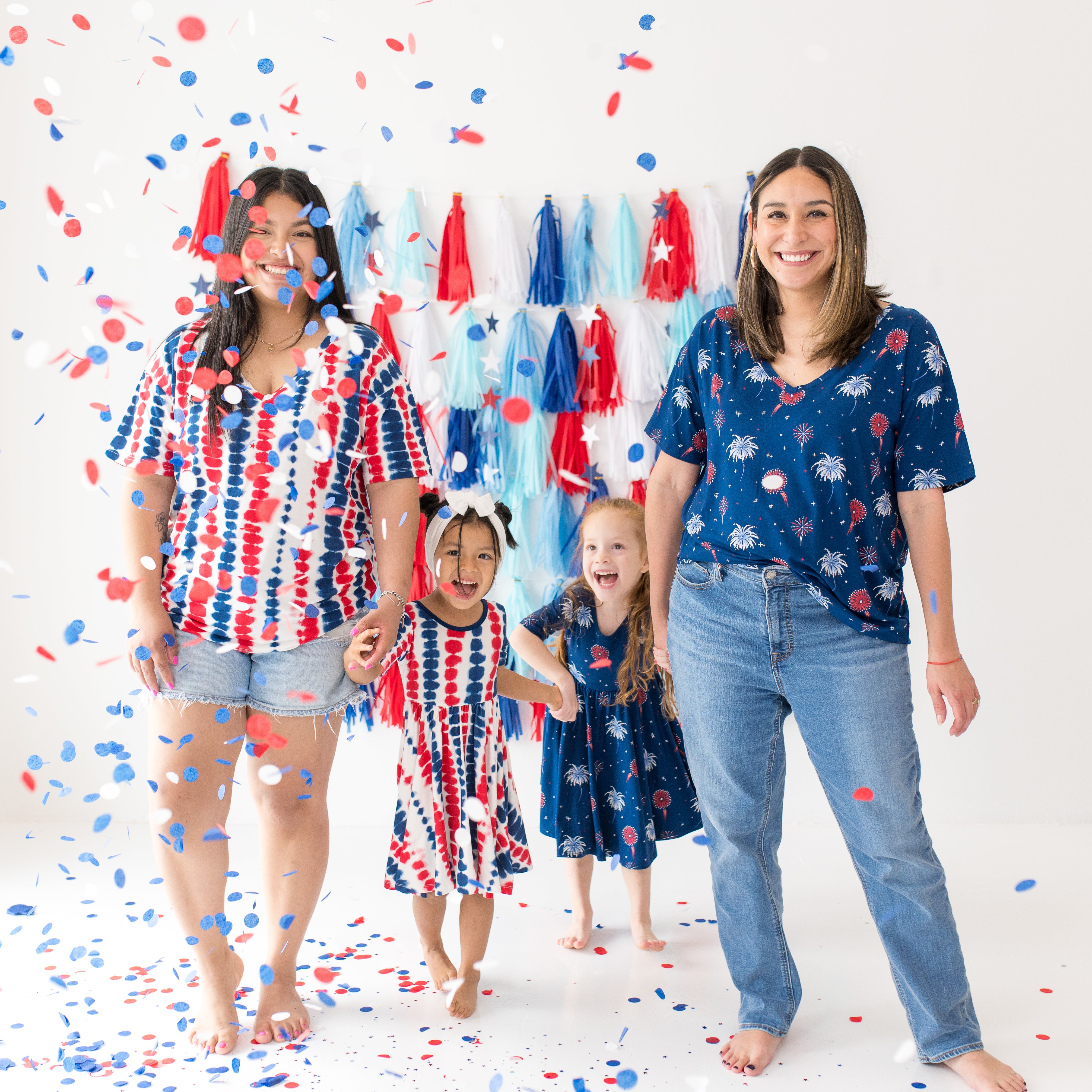 Group of moms and children wearing Liberty Rip Tide and Celebration in V-necks and twirl dresses
