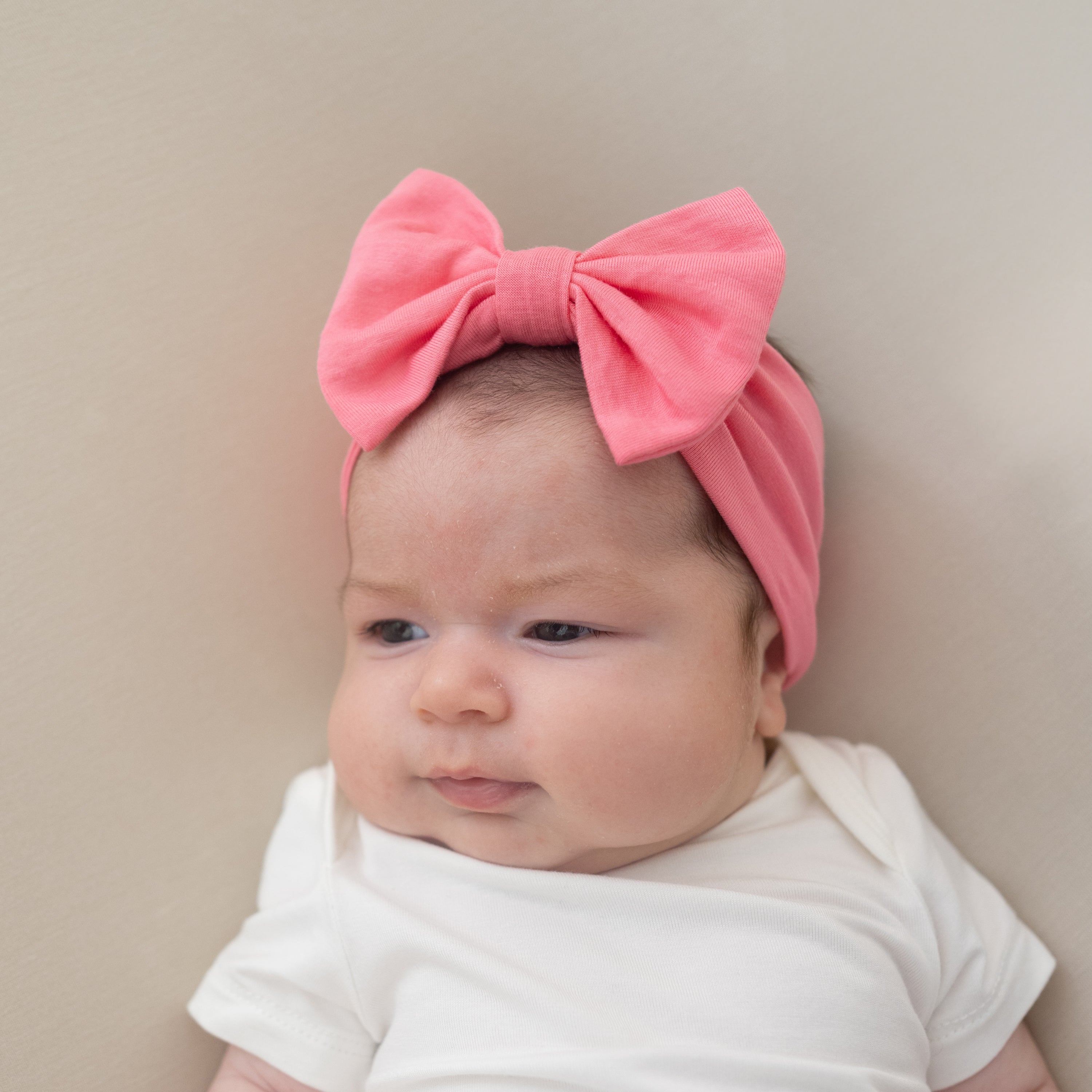 Baby wearing Bow Headband in Guava and cloud bodysuit