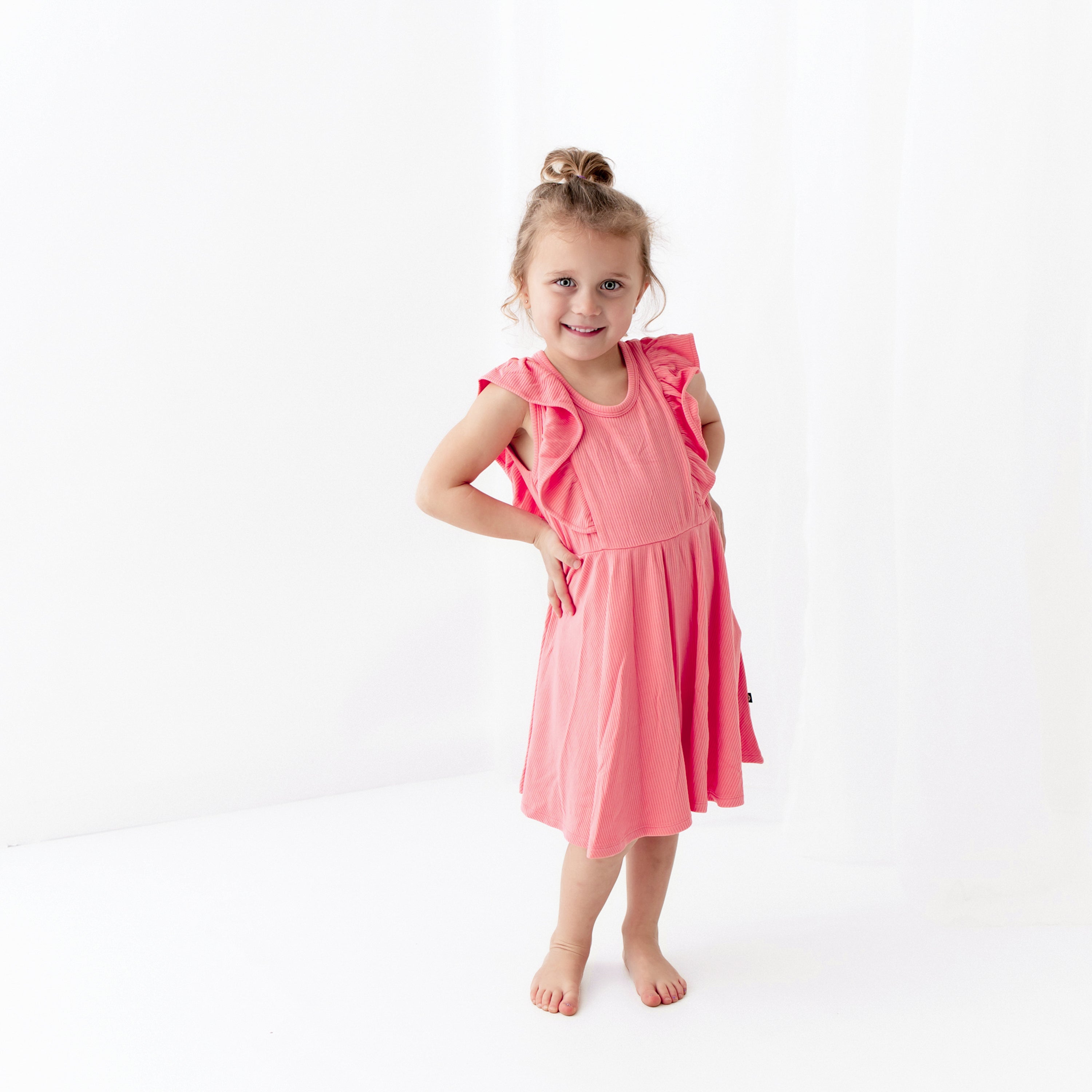 Girl wearing Ribbed Peplum Dress Set in Guava