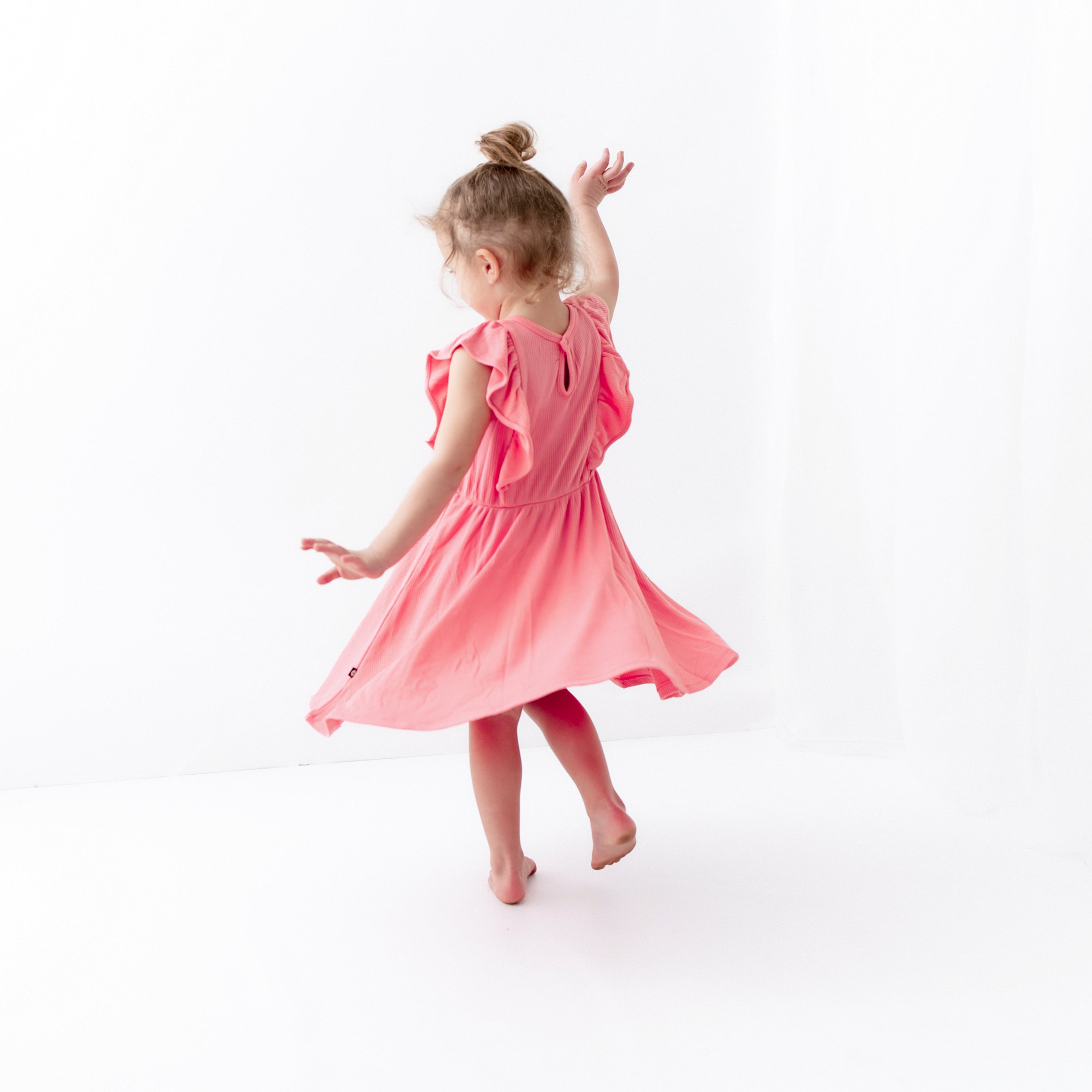 Girl wearing Ribbed Peplum Dress Set in Guava with Flutter Sleeves