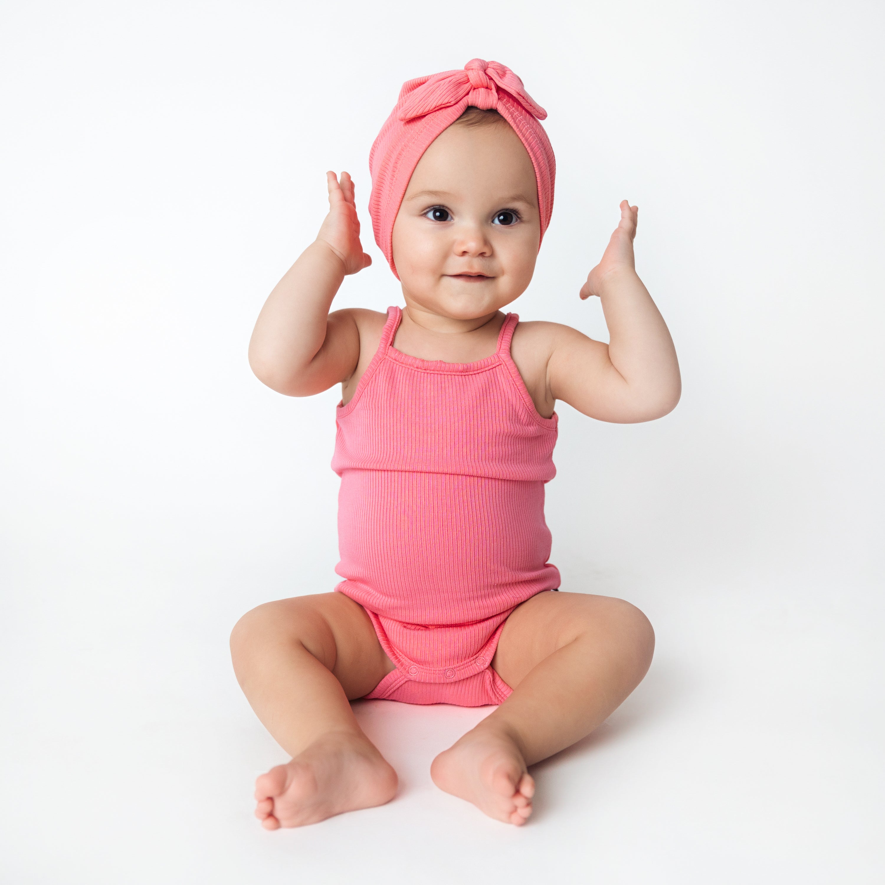 Baby wearing Ribbed Spaghetti Strap Bodysuit in Guava with Matching Headwrap