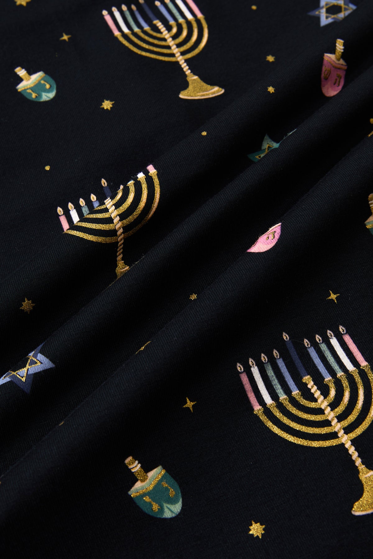 Close up of Black fabric with Hanukkah Nights print