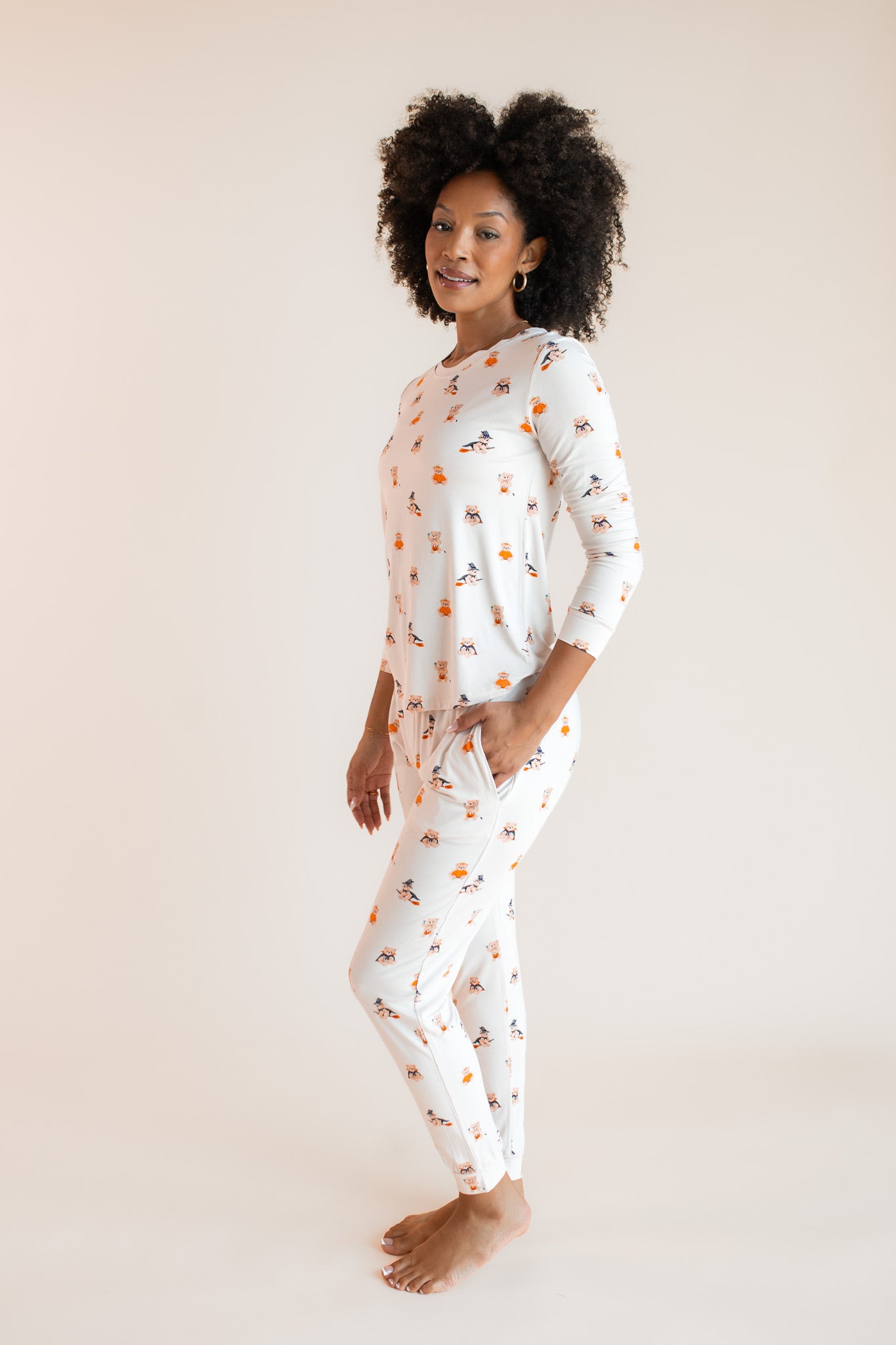 Modal posing with hand in pocket wearing Women's Jogger Pajama Set in Halloween Teddy print on a beige background
