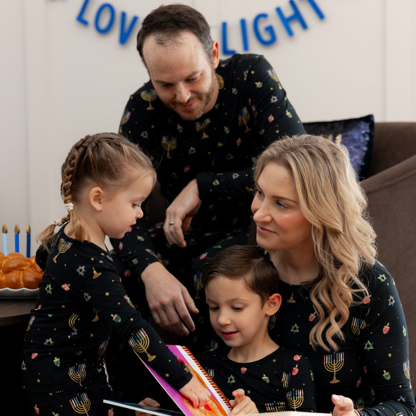 Family of 4 in matching Hanukkah pajamas