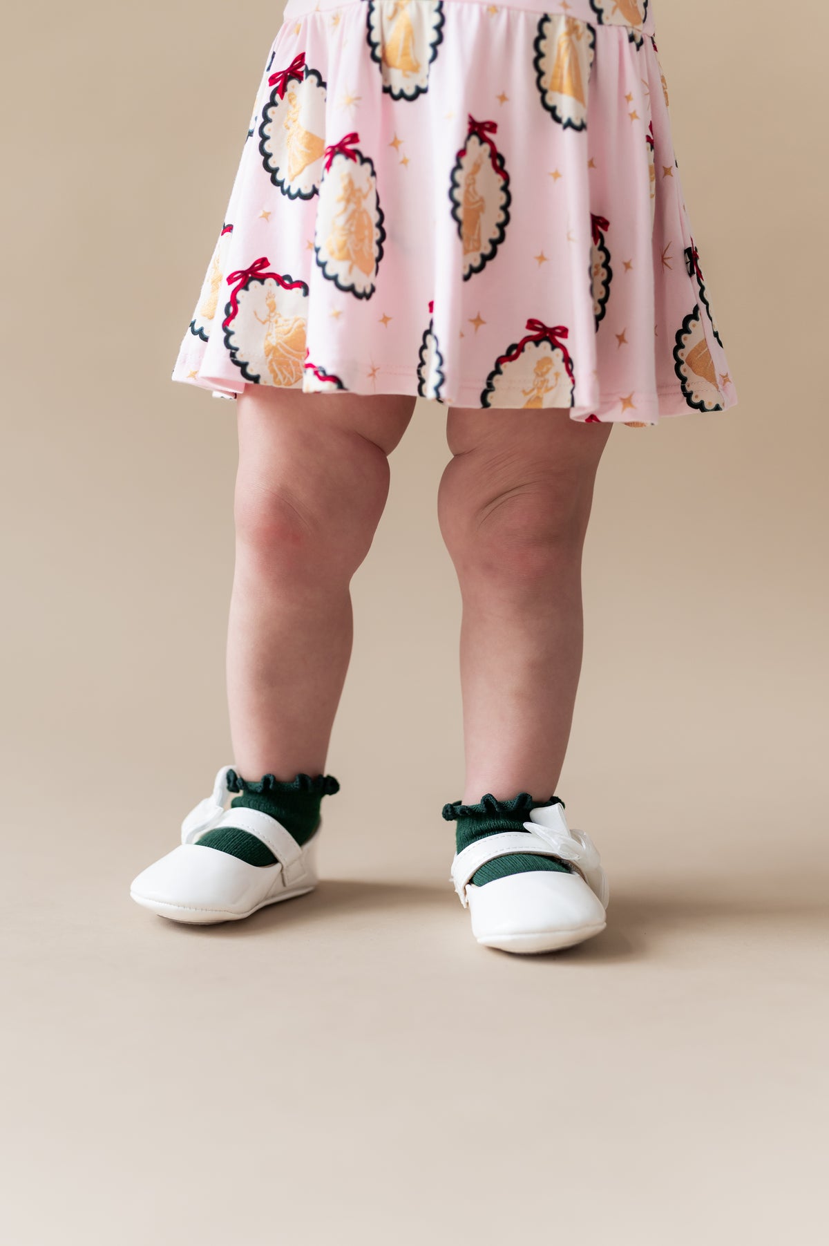 Toddler wearing kids Ruffle Socks in green color on white shoes under princess portrait print dress