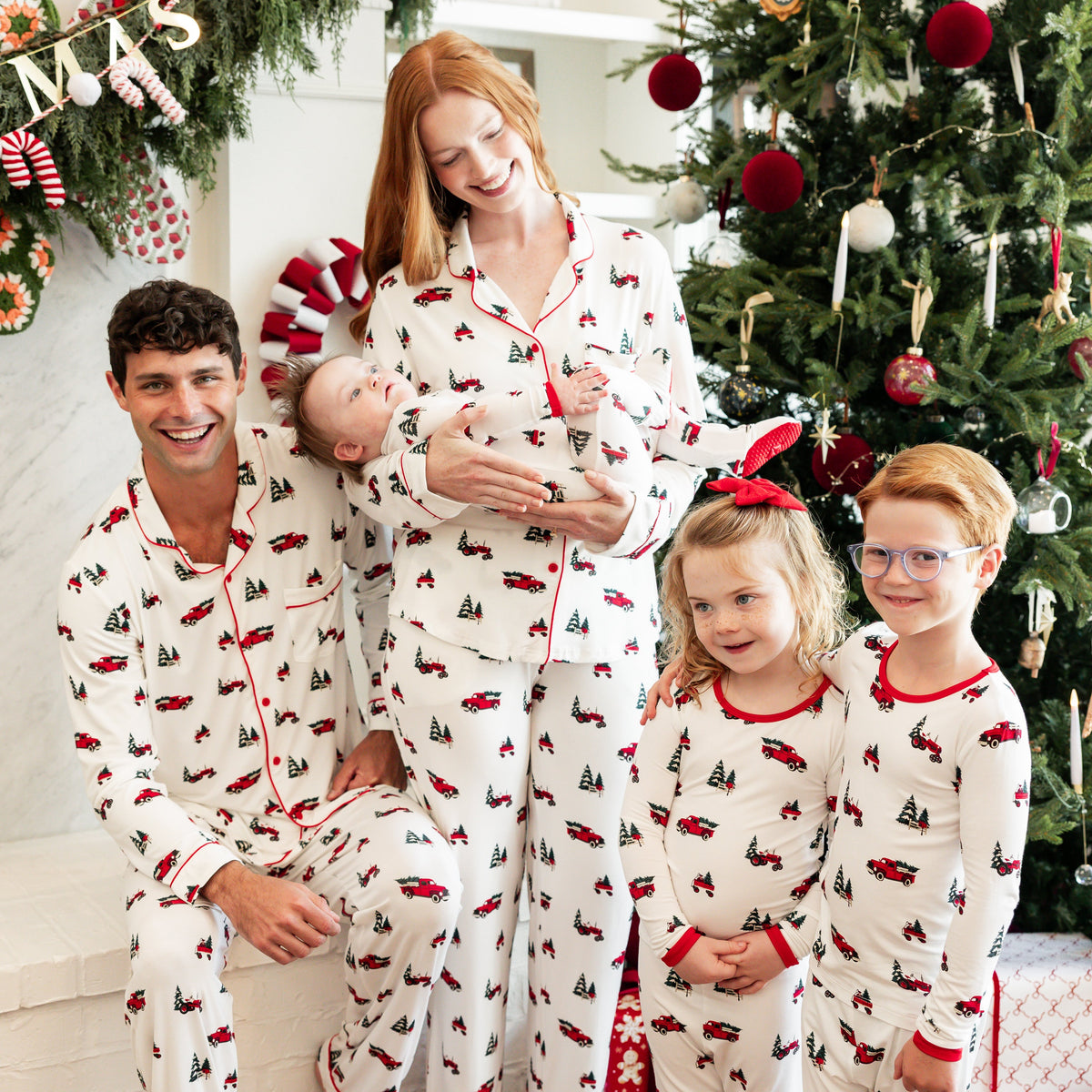 Family of 5 wearing Holiday Tree Farm matching pajamas