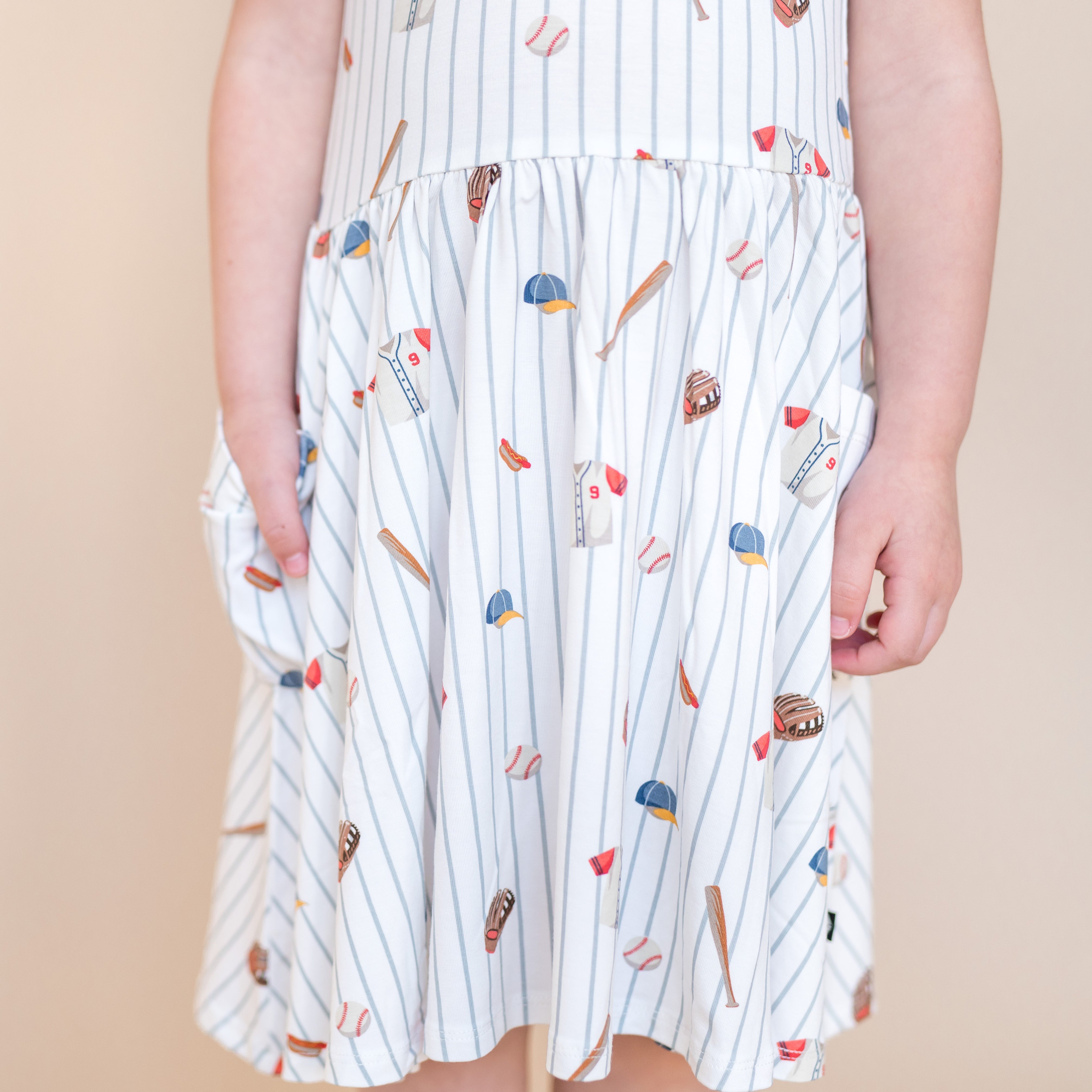 The skirt of the Pocket Dress in Home Run shown on a young girl