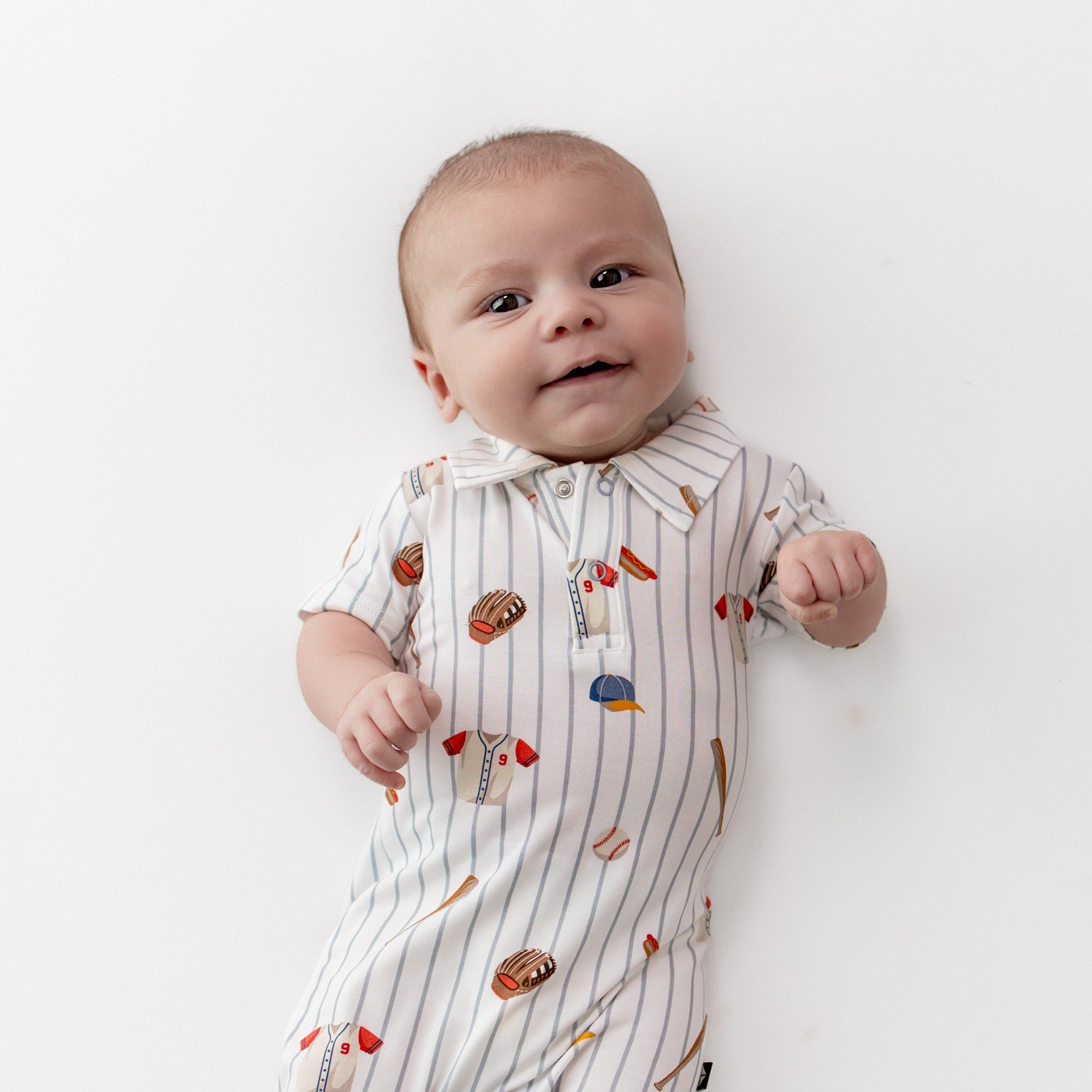 Close up of an infant wearing the Polo Shortall in Home Run