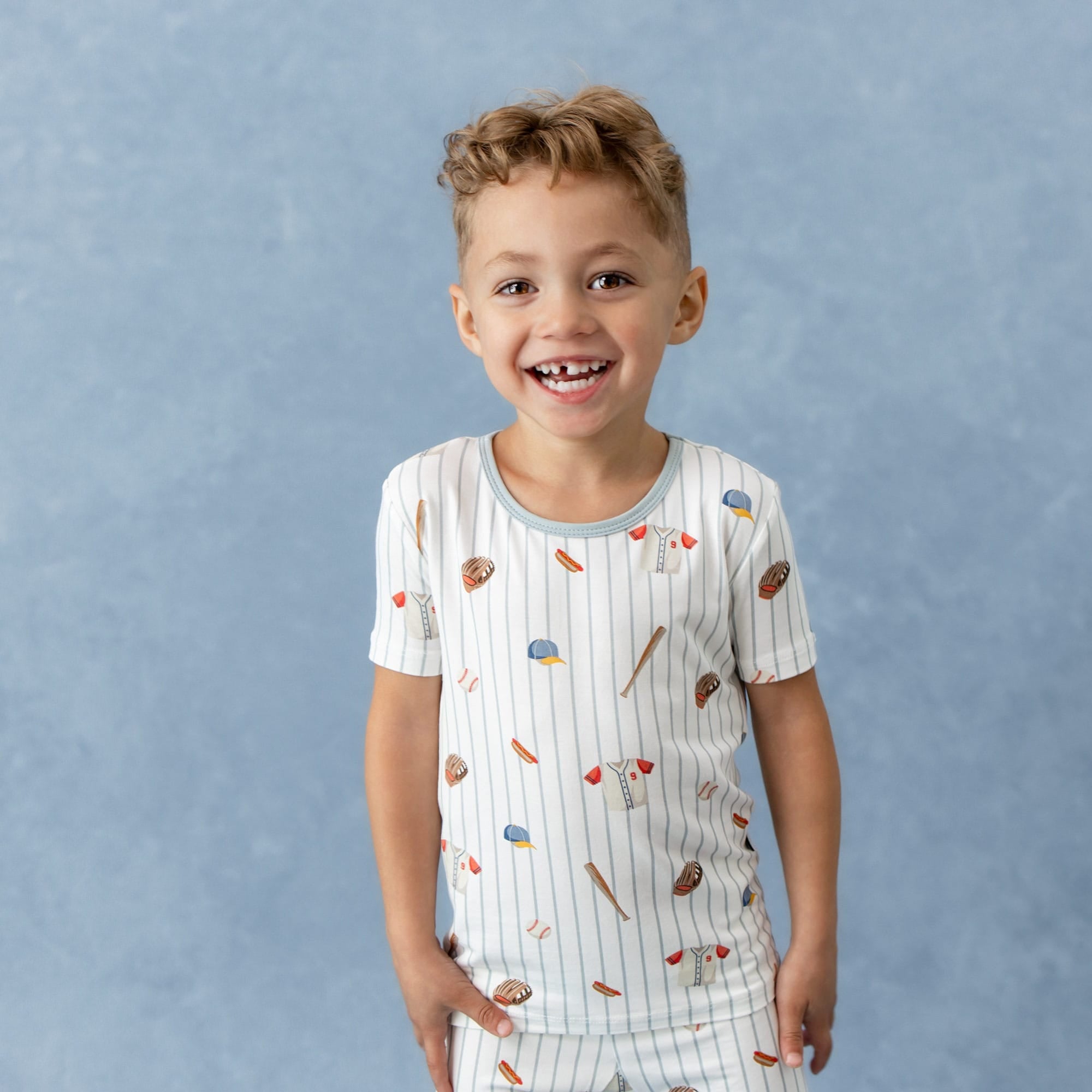 Smiling boy wearing the Short Sleeve Pajamas in Home Run
