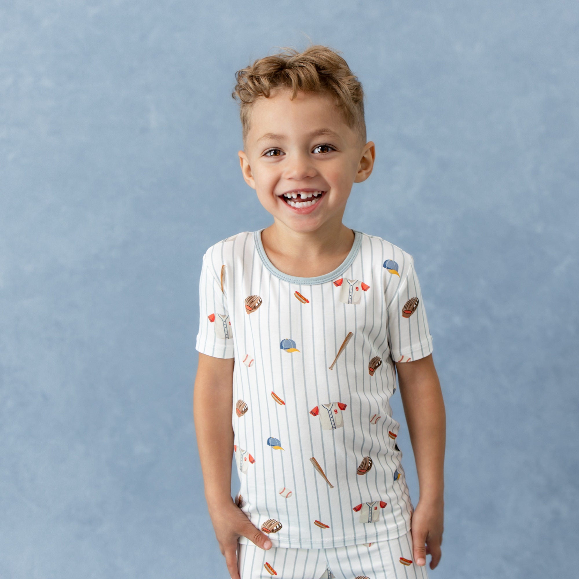 Smiling boy wearing the Short Sleeve Pajamas in Home Run