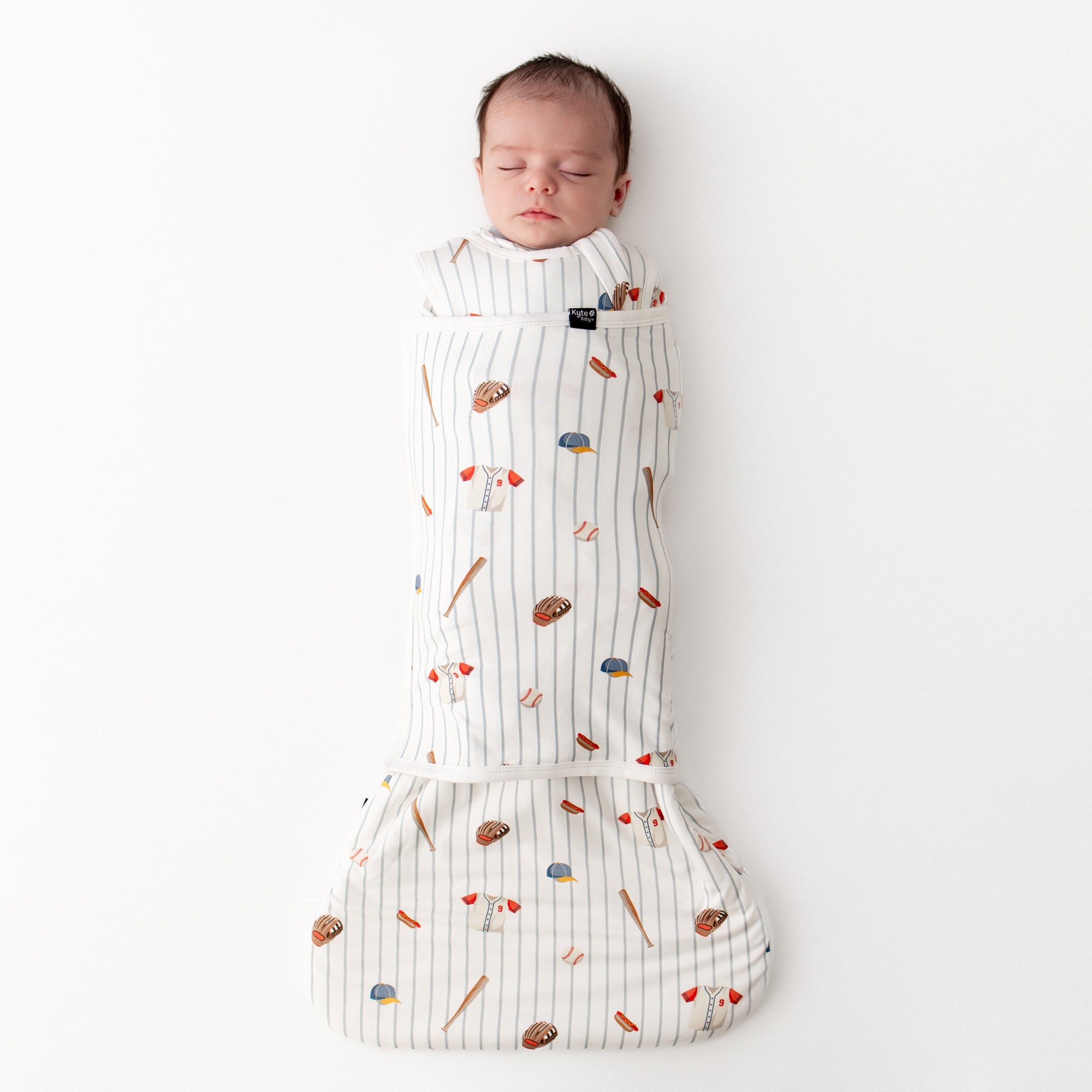 Sleeping newborn swaddled in the Sleep Bag Swaddler in Home Run 1.0