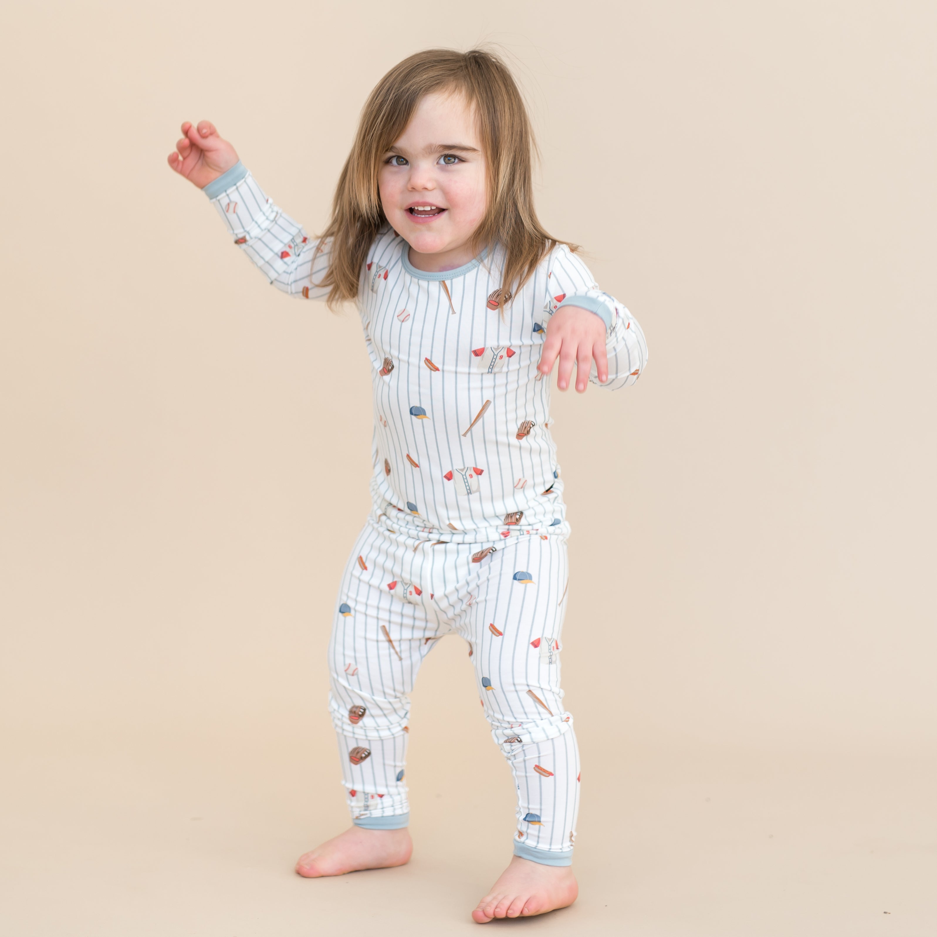 Young child walking wearing the Long Sleeve Pajamas in Home Run