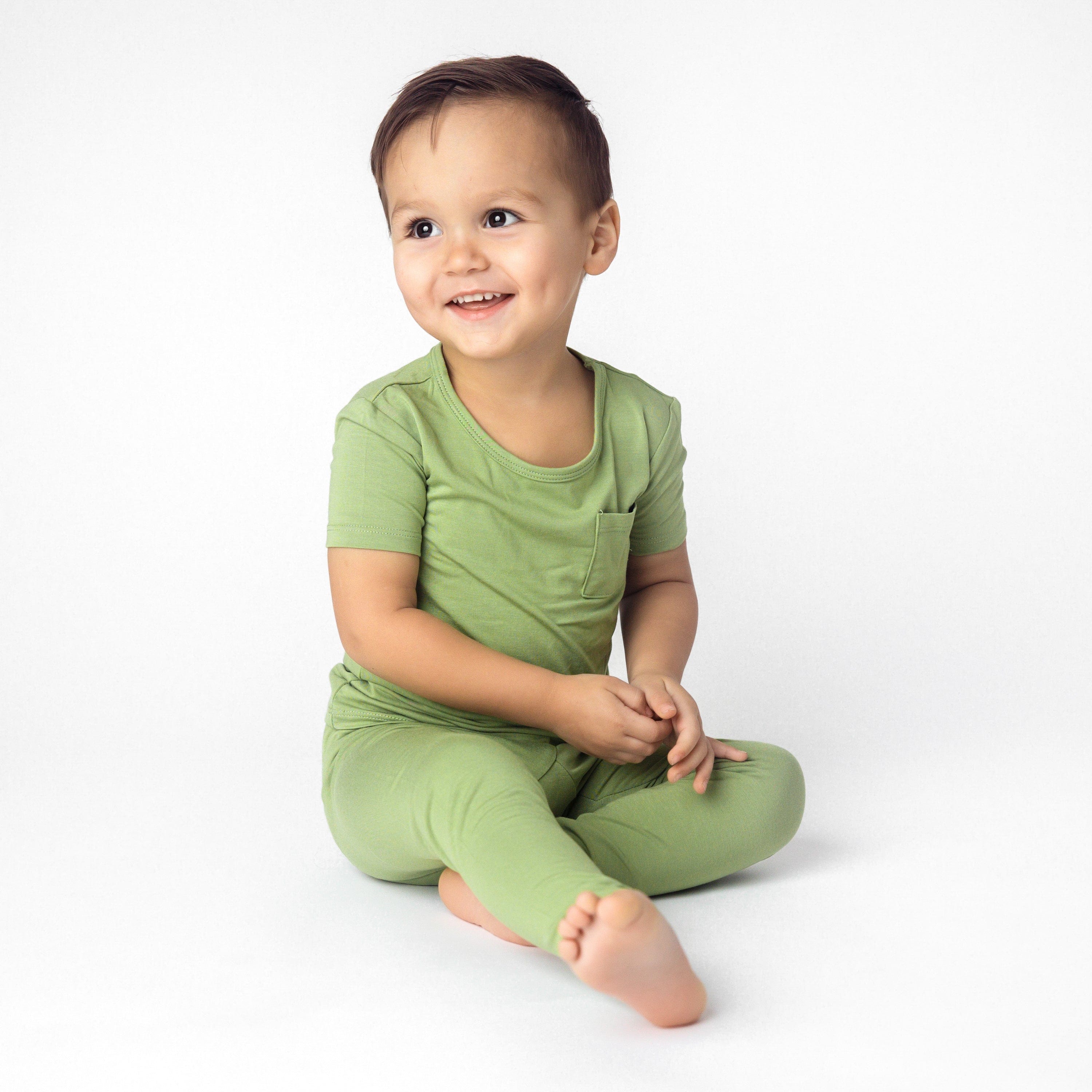 Toddler wearing Short Sleeve Bamboo PJs with Pants in Honu green