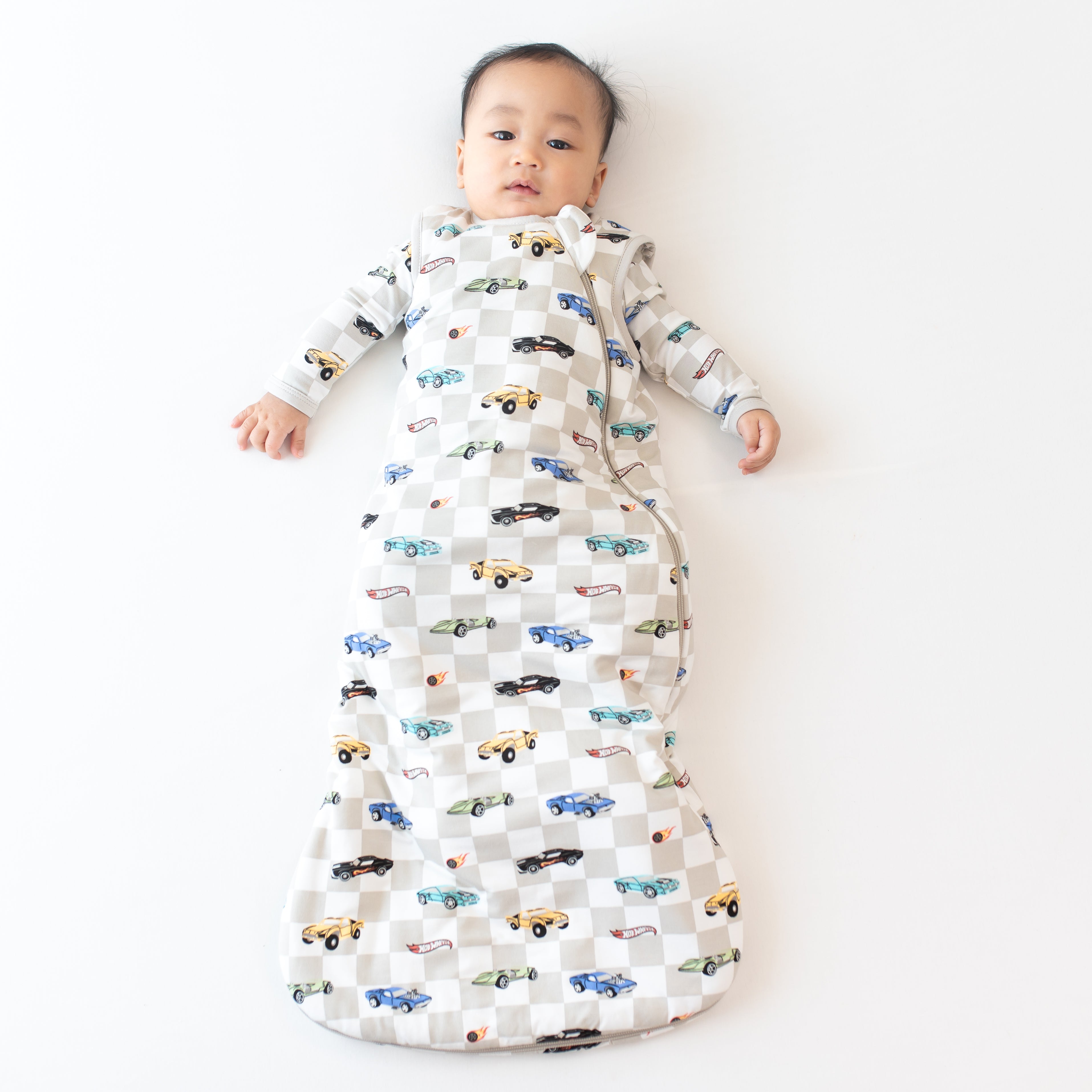 Infant wearing the Sleep Bag in Fast and Fierce 1.0 TOG with matching pajamas