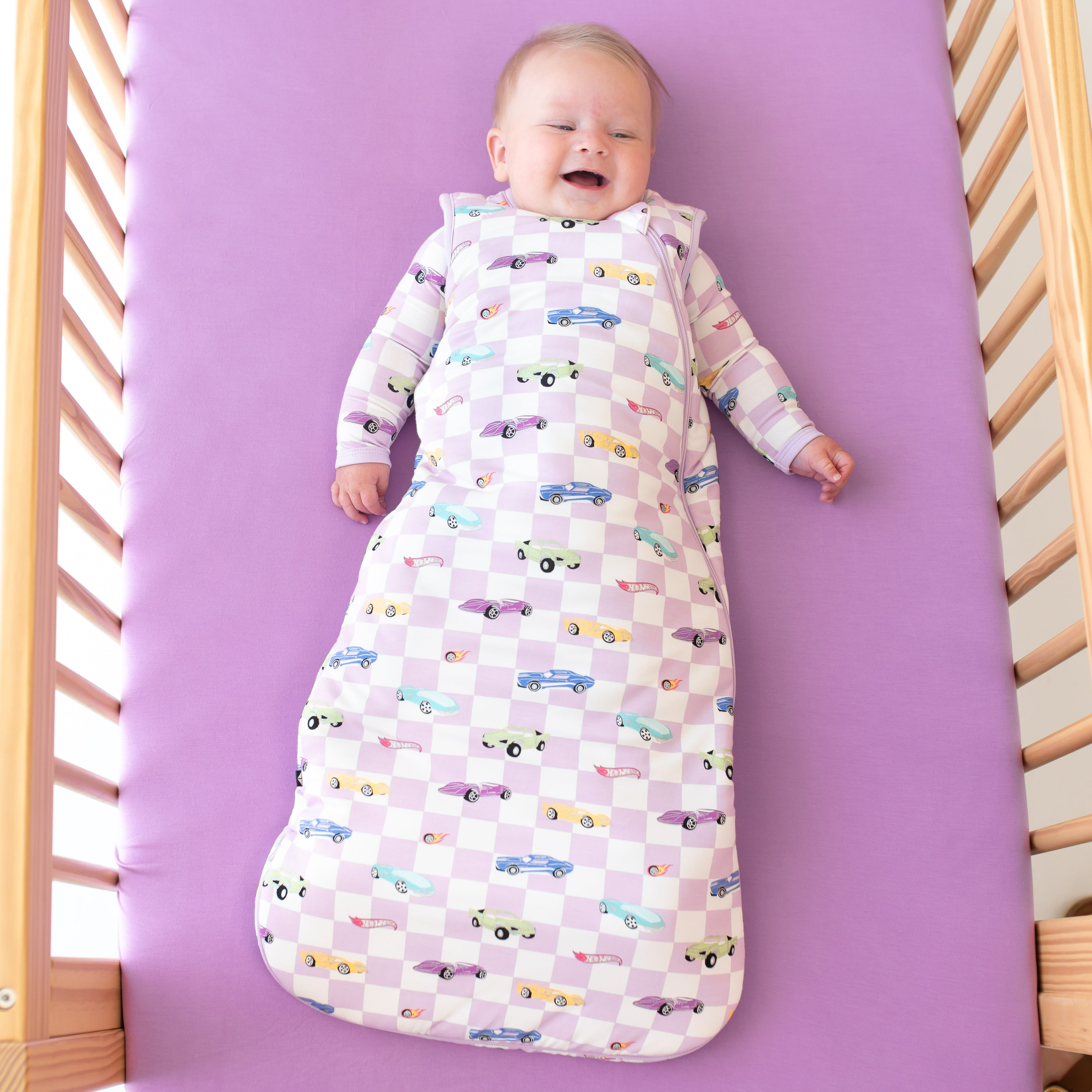 Infant wearing Hot Wheels Sleep Bag in Sparkles and Speed 2.5 TOG with bamboo pajamas