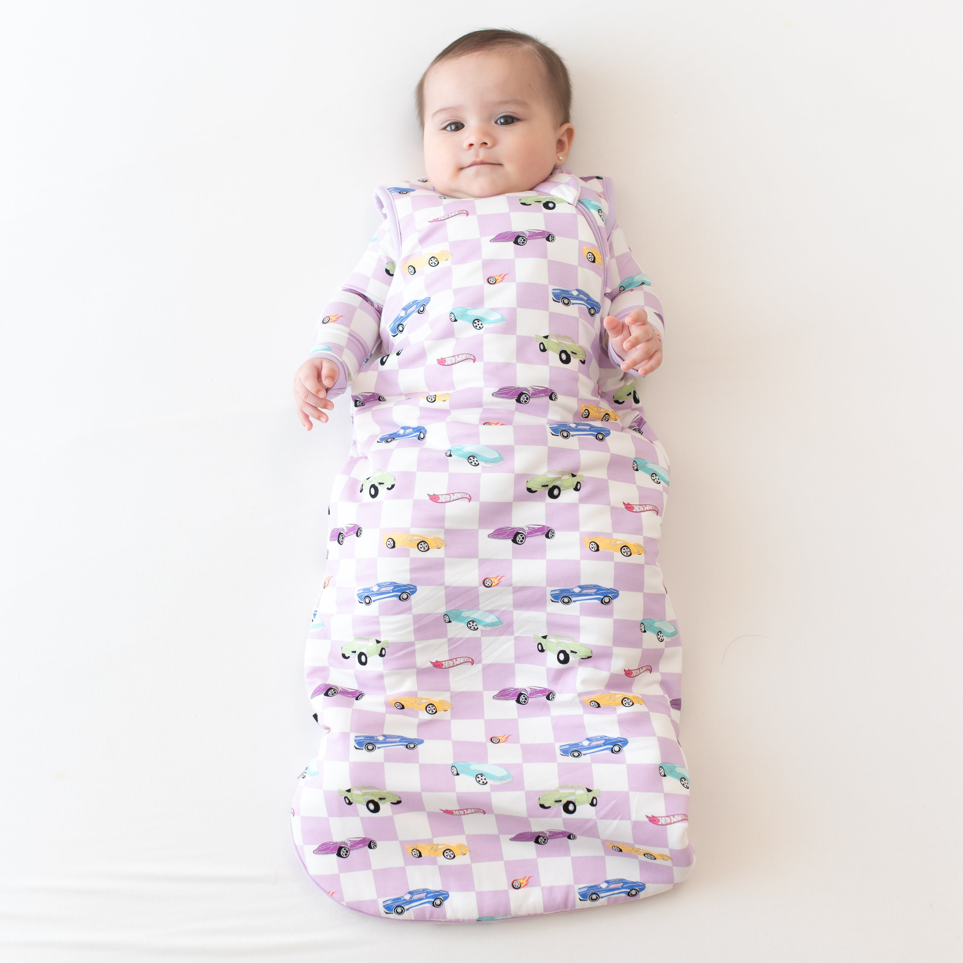 Infant wearing Sleep Bag in Sparkles and Speed 1.0 with matching long sleeve Hot Wheels pajamas