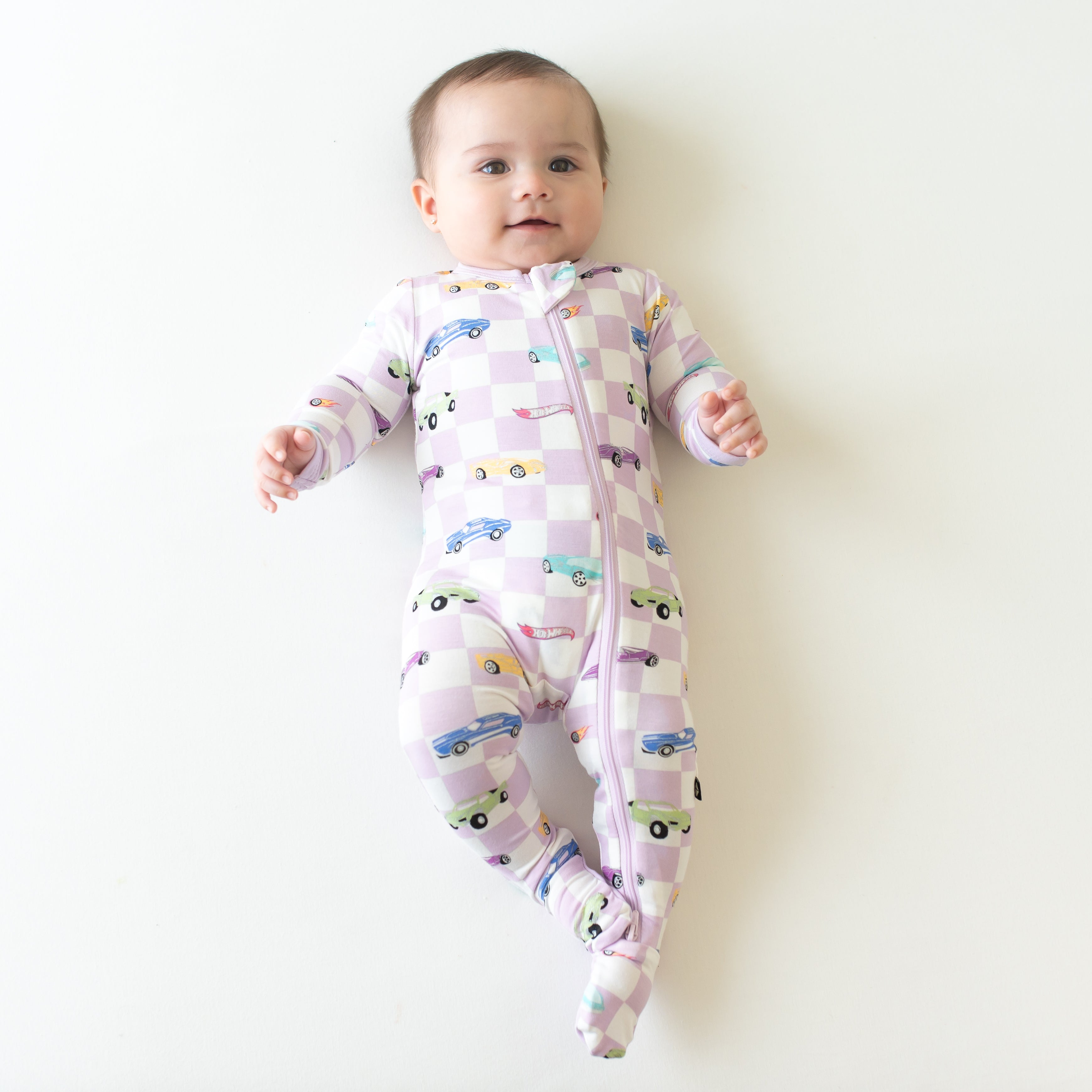 Infant wearing Hot Wheels Zippered Footie pajamas in Sparkles and Speed