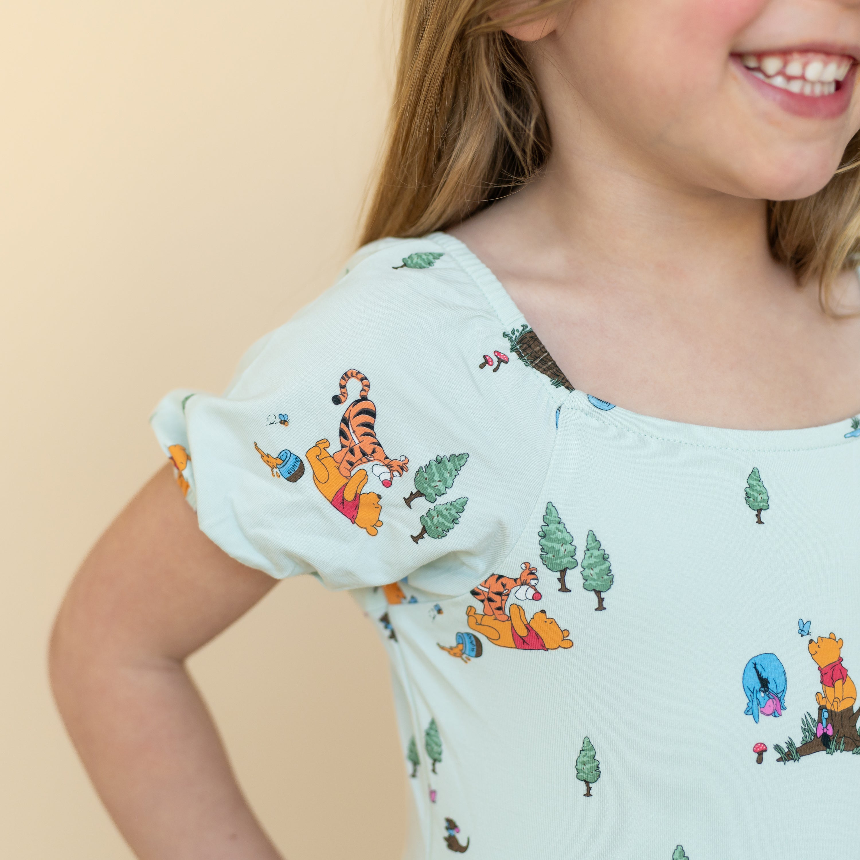 Close up of the puff sleeve on the Puff Sleeve Twirl Dress in Winnie the Pooh Hundred Acre Wood