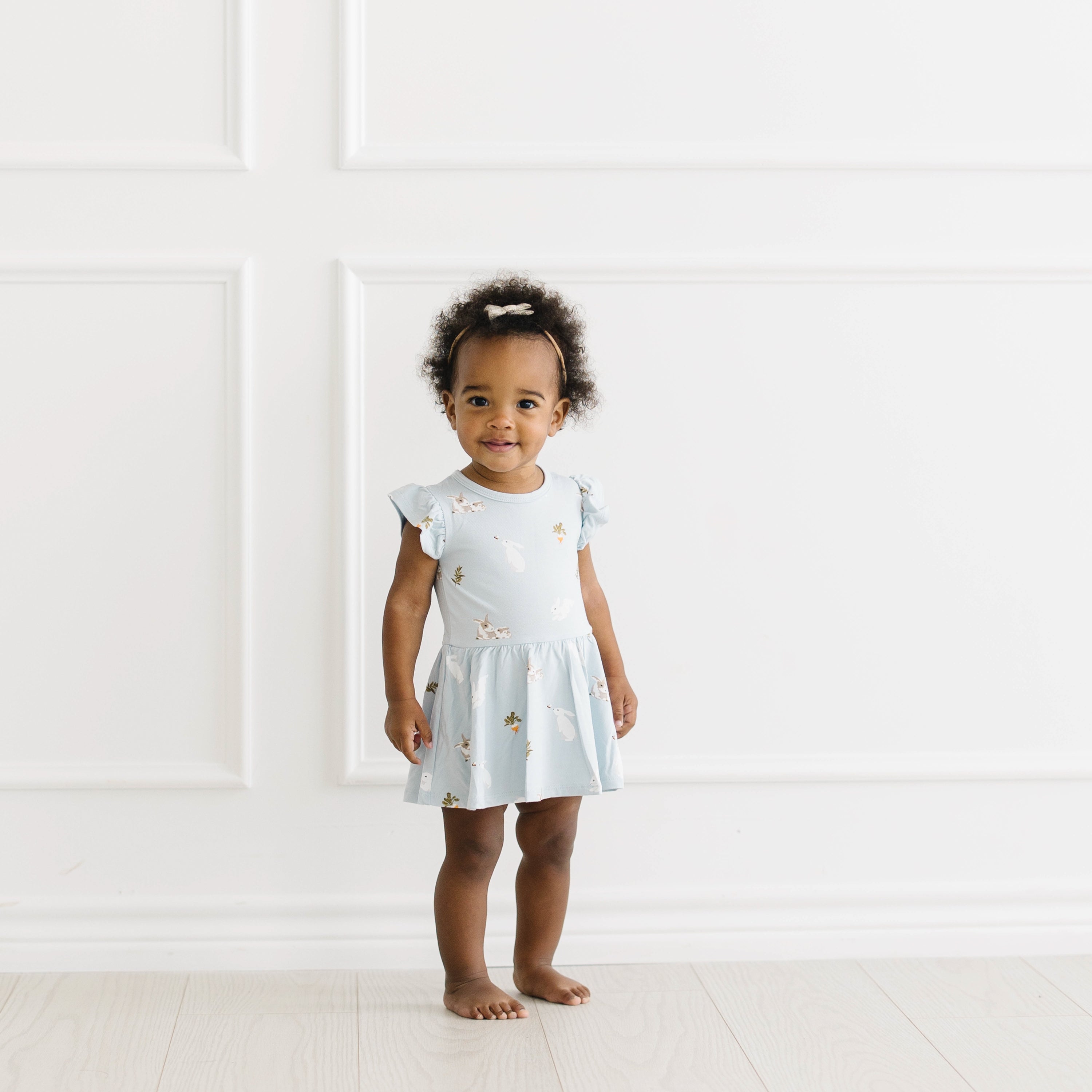 Toddler wearing blue Twirl Bodysuit Dress in Ice Rabbit