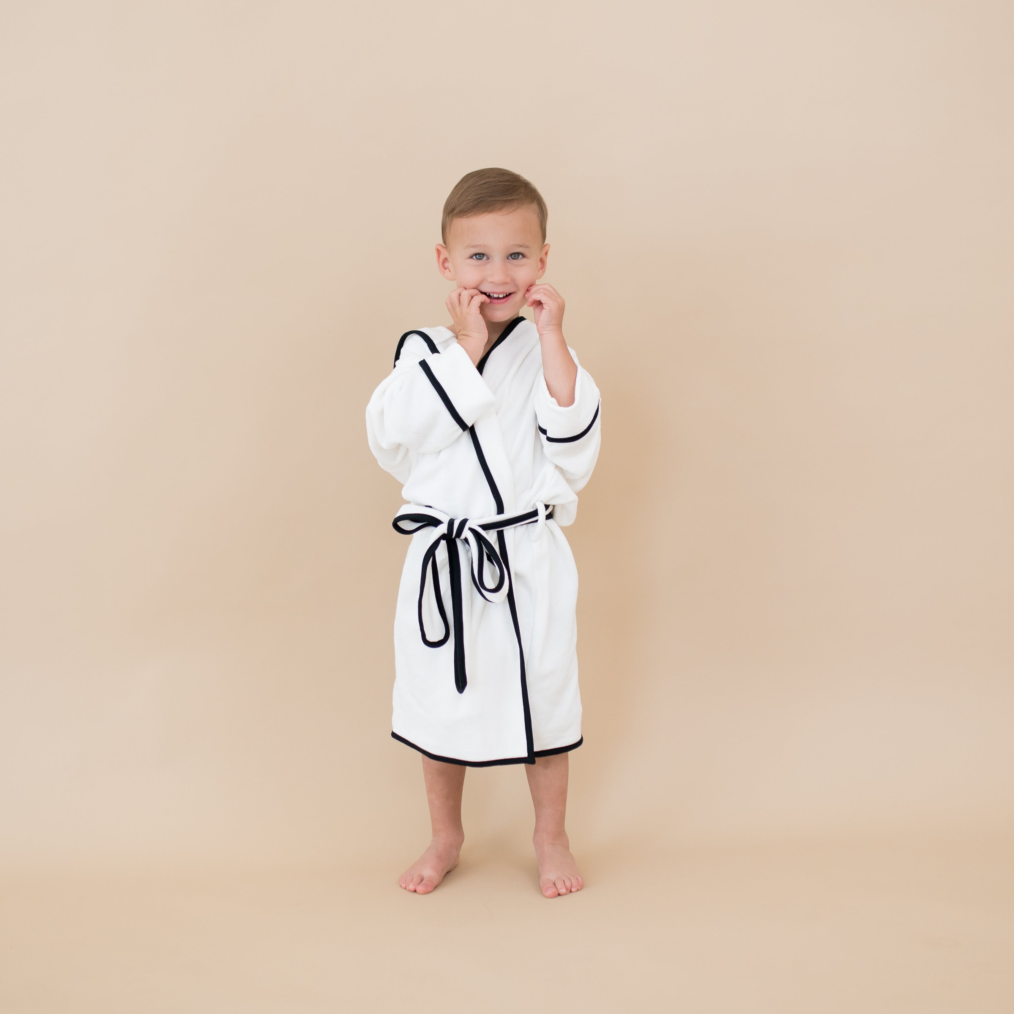 Boy wearing Hooded Bath Robe in Cloud with Midnight Trim