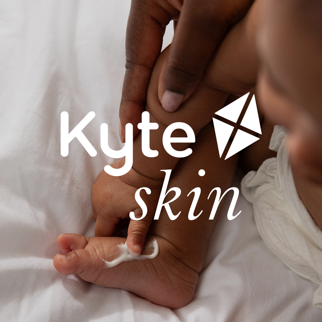 Baby's foot being held with 'Kyte Skin' logo overlay