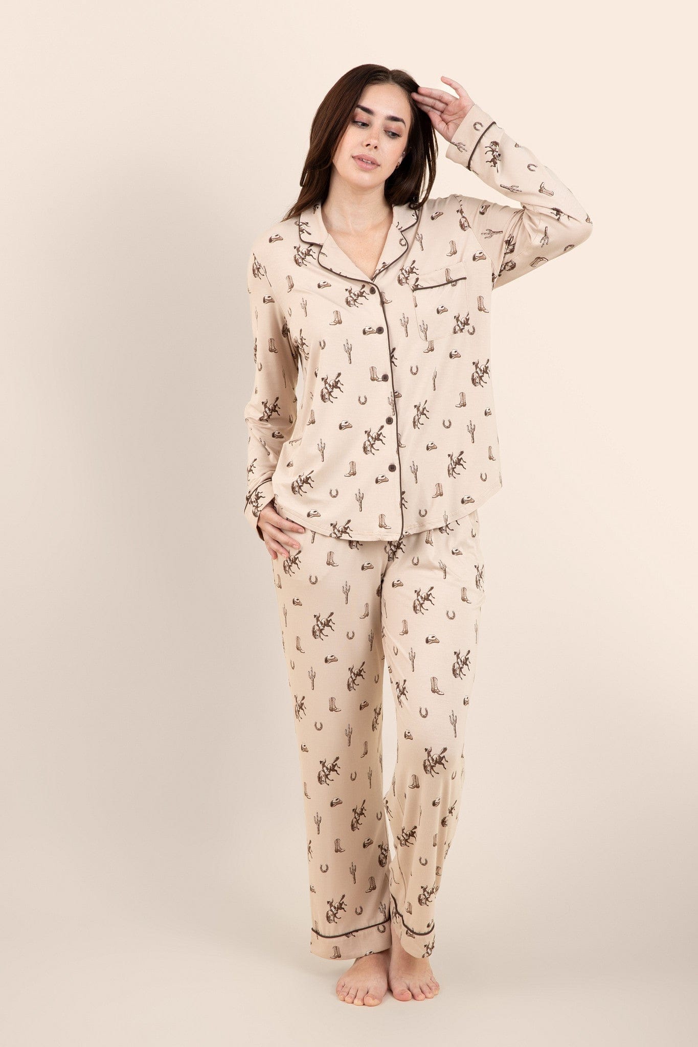 Female modeling the Long-Sleeved Women's Pajama Set in Classic Cowboy in front of a light neutral background