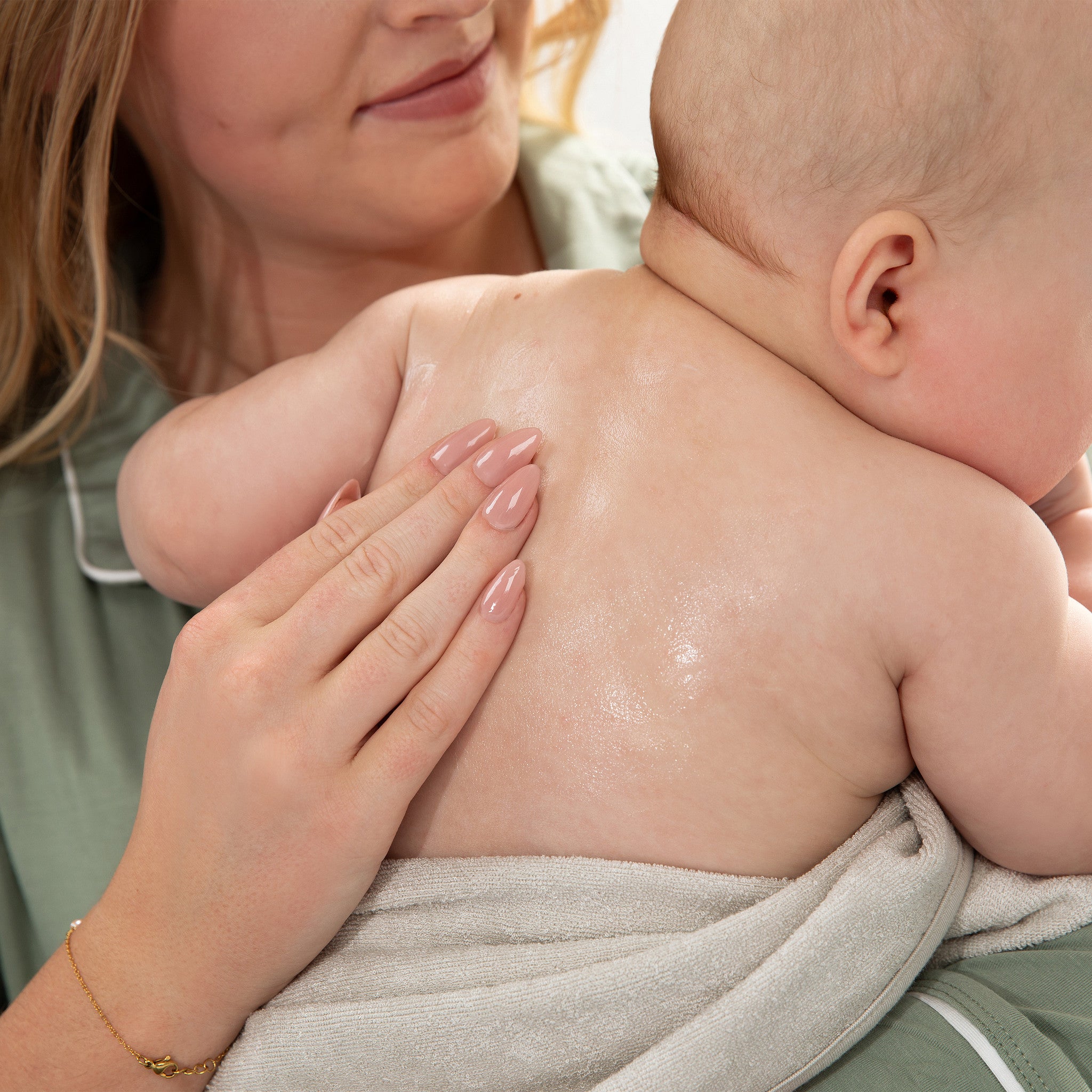 Woman holding a baby close, with a soft focus background