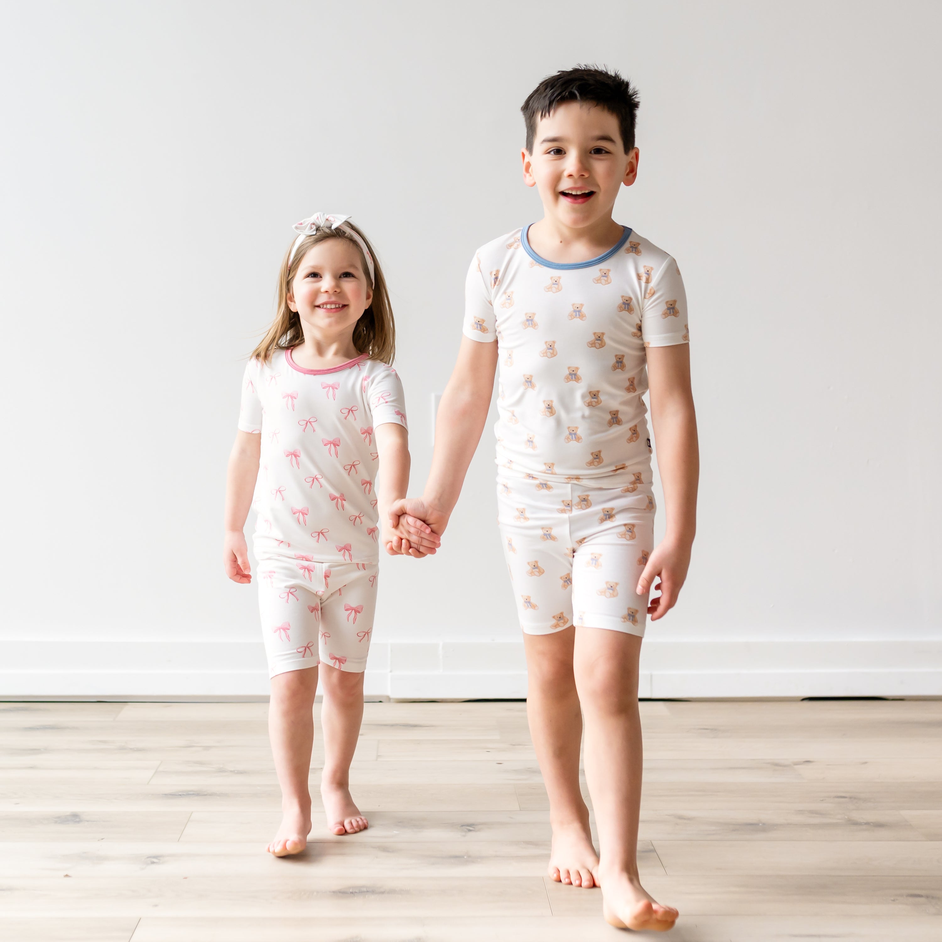 Two siblings wearing matching pajamas in Bow and Teddy Bear