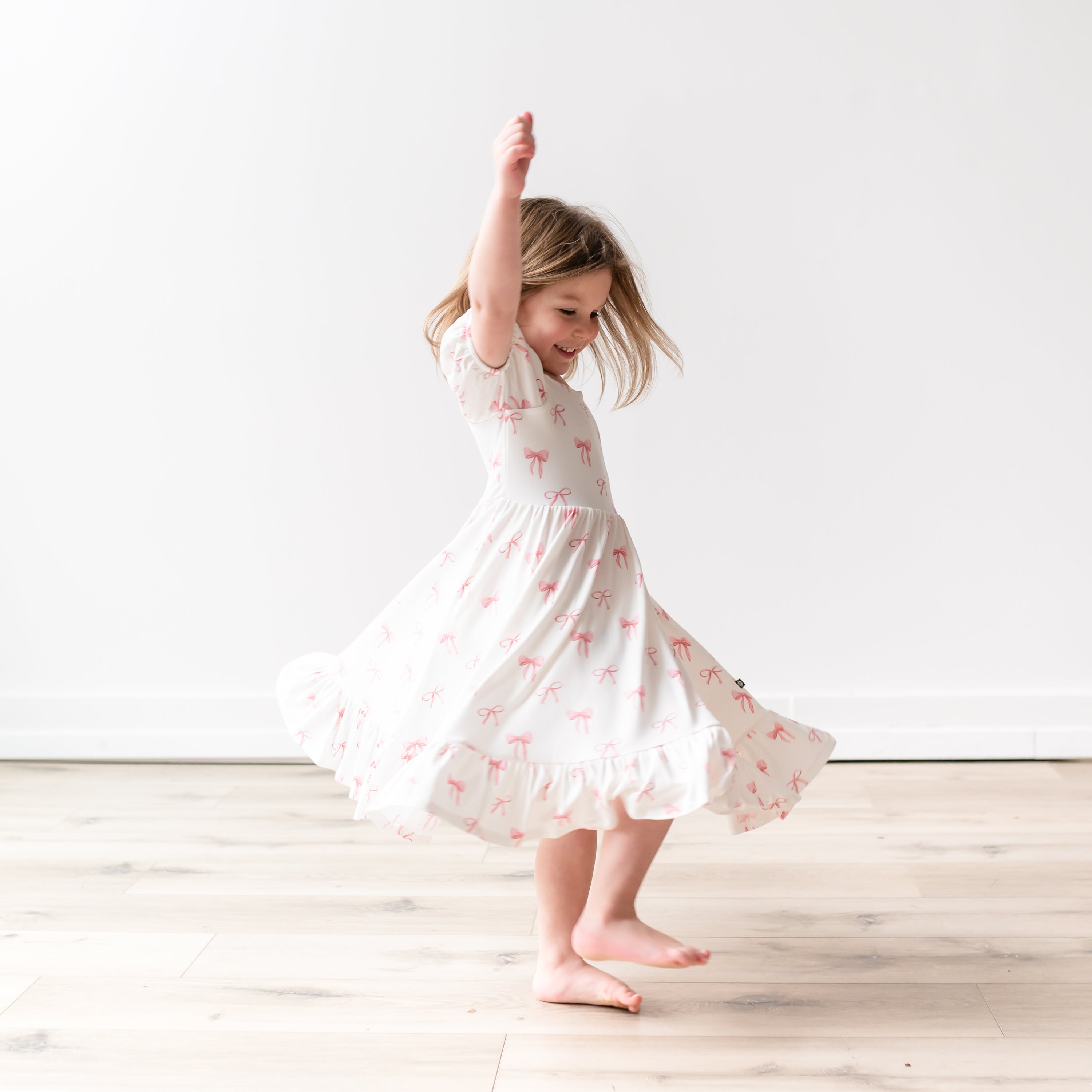 Modeling twirling in Puff Sleeve Twirl Dress in Bow